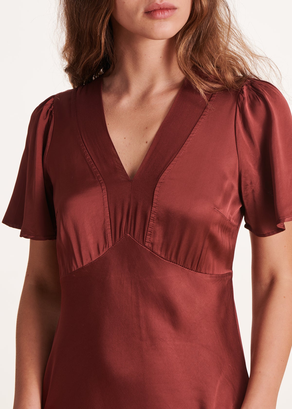 Long flowing burgundy fitted dress with short sleeves