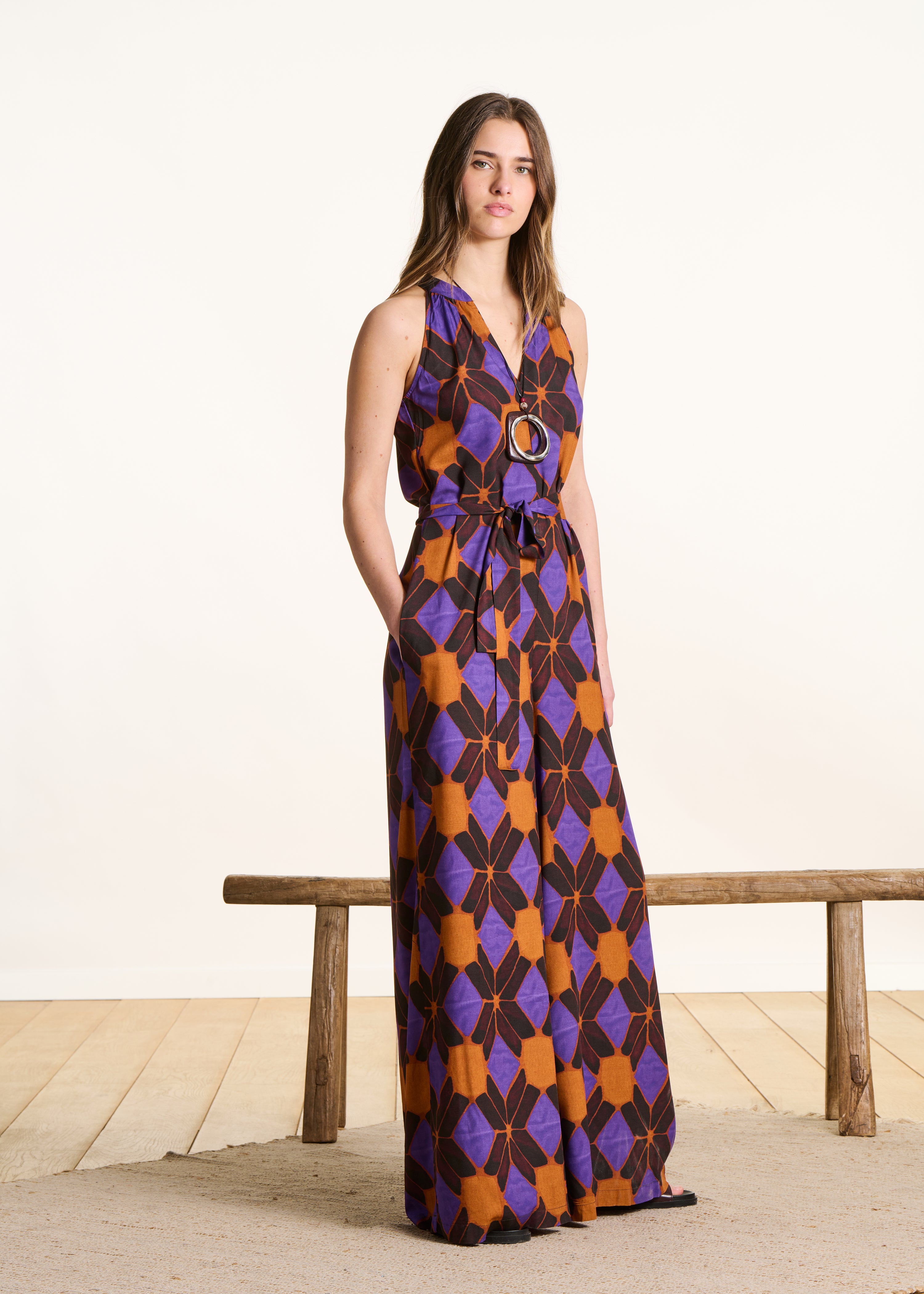 Sleeveless jumpsuit with orange and purple print