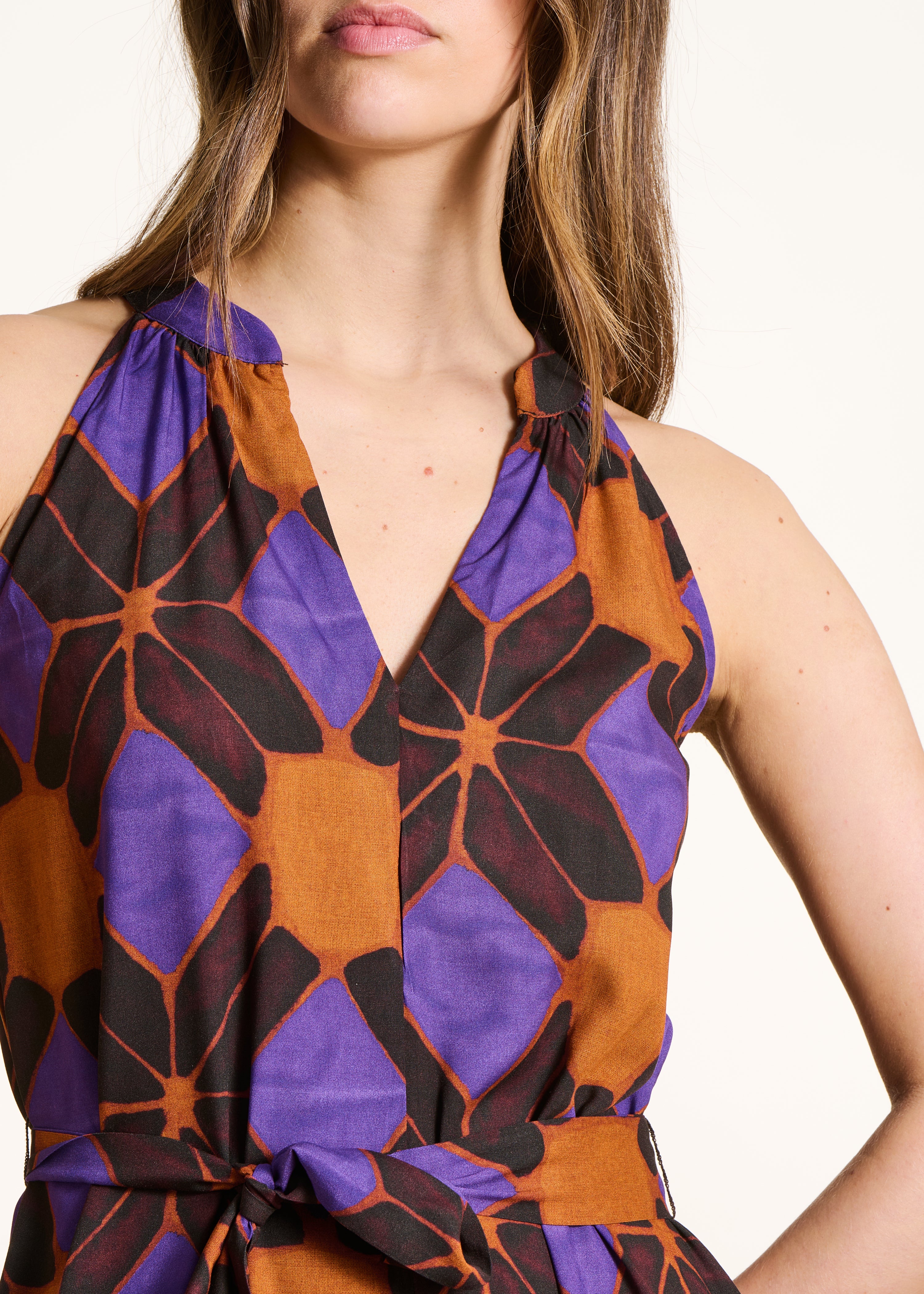 Sleeveless jumpsuit with orange and purple print