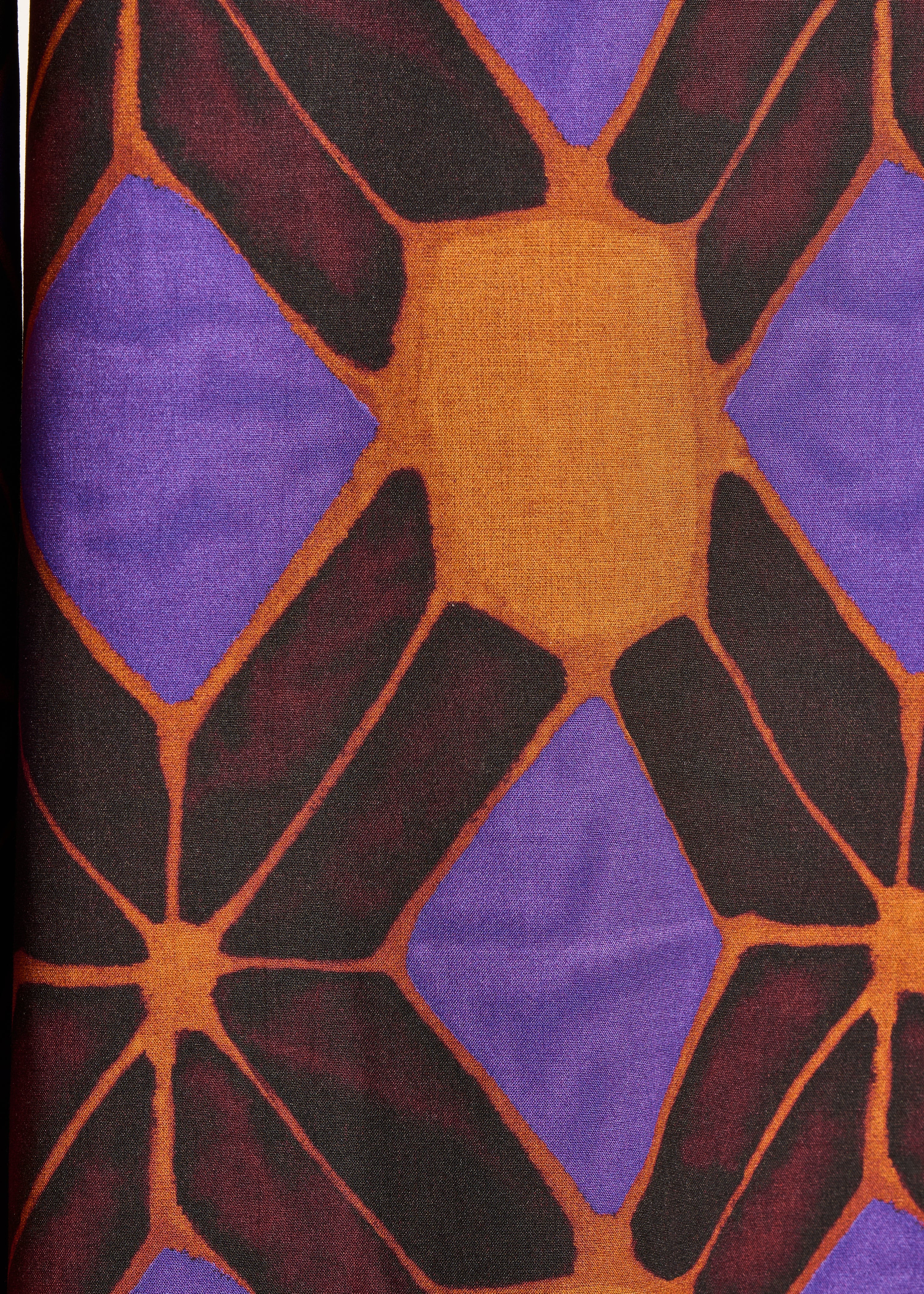 Sleeveless jumpsuit with orange and purple print