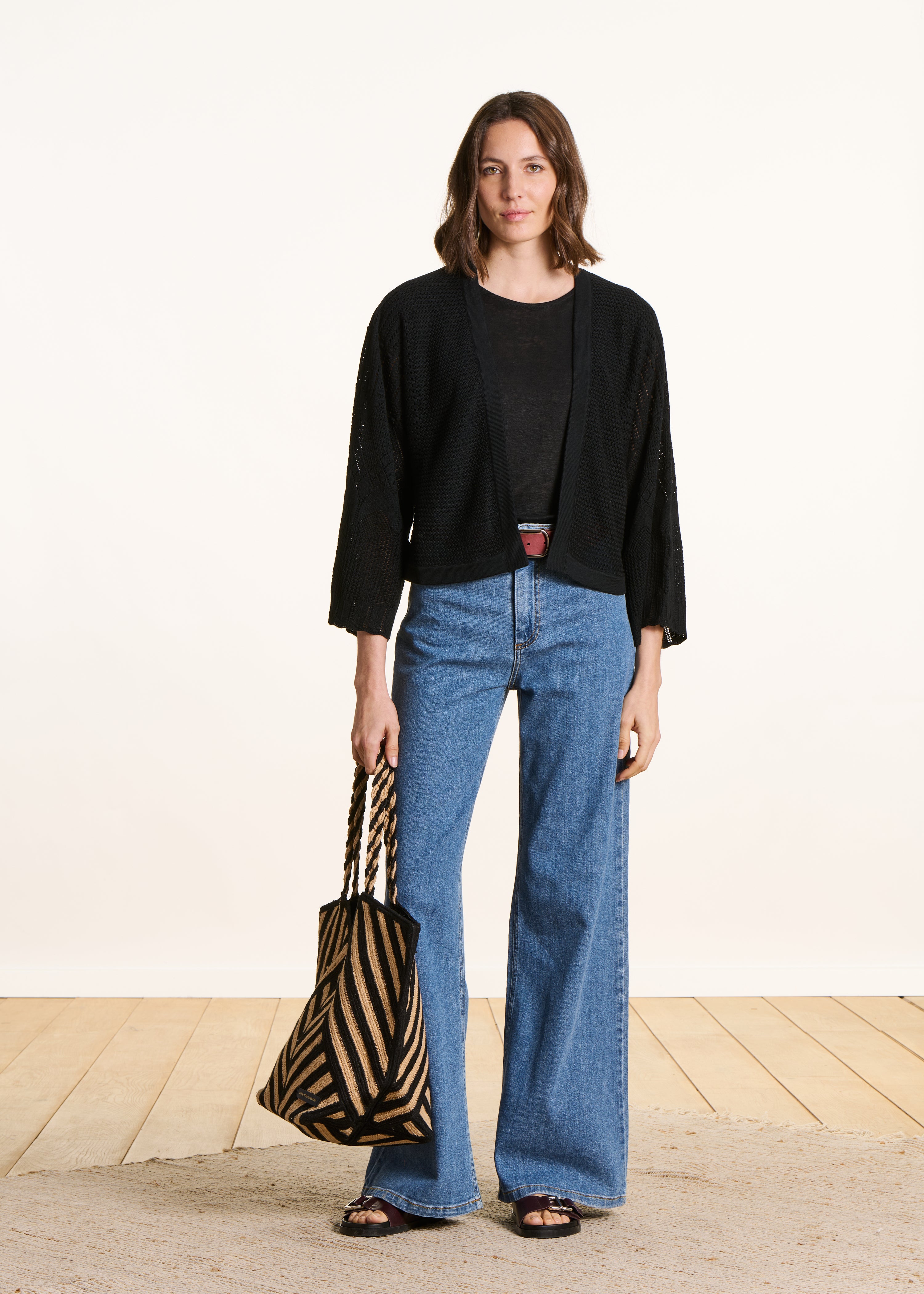 Short black cardigan in pointelle knit
