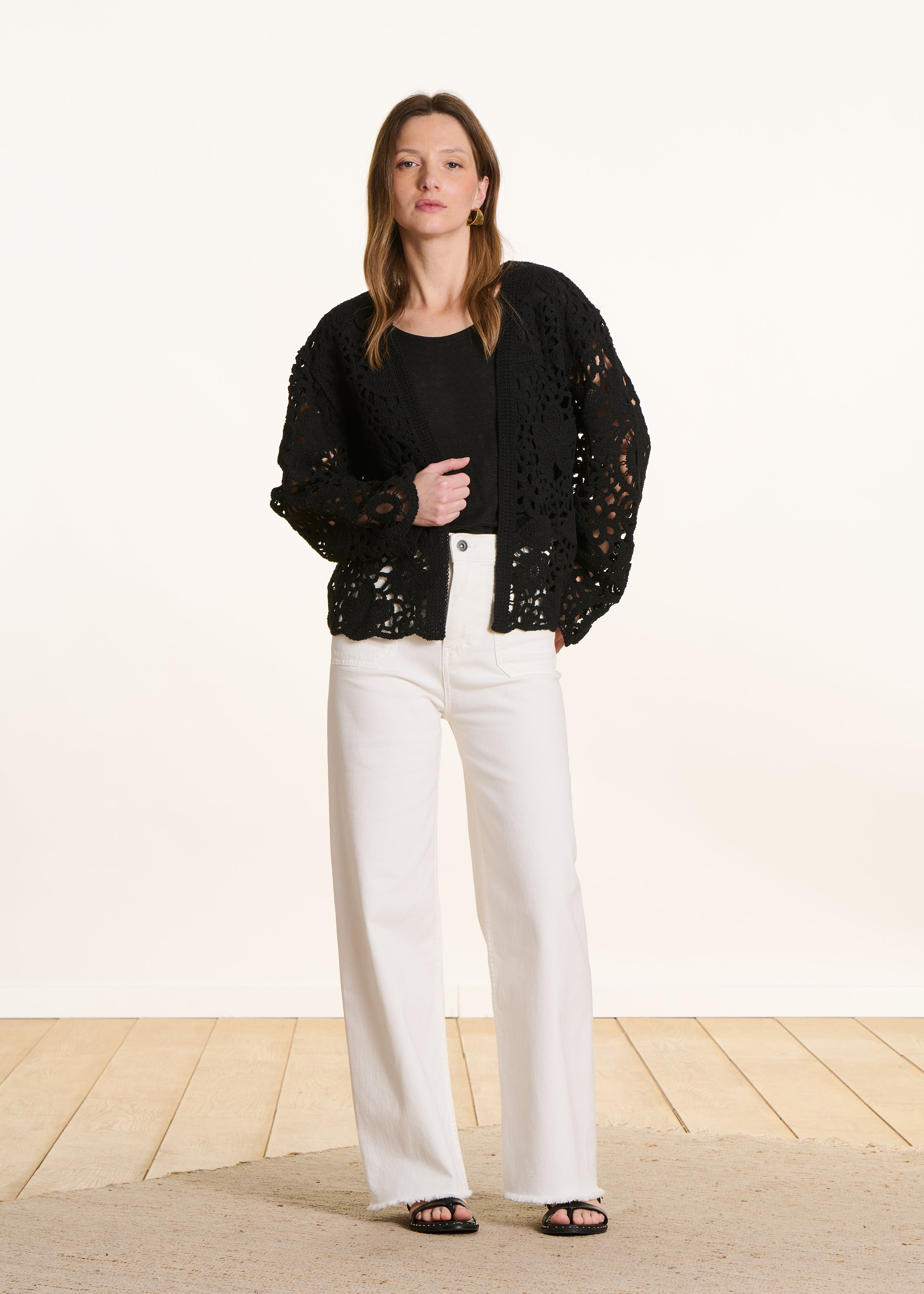 Open short cardigan in black crochet knit