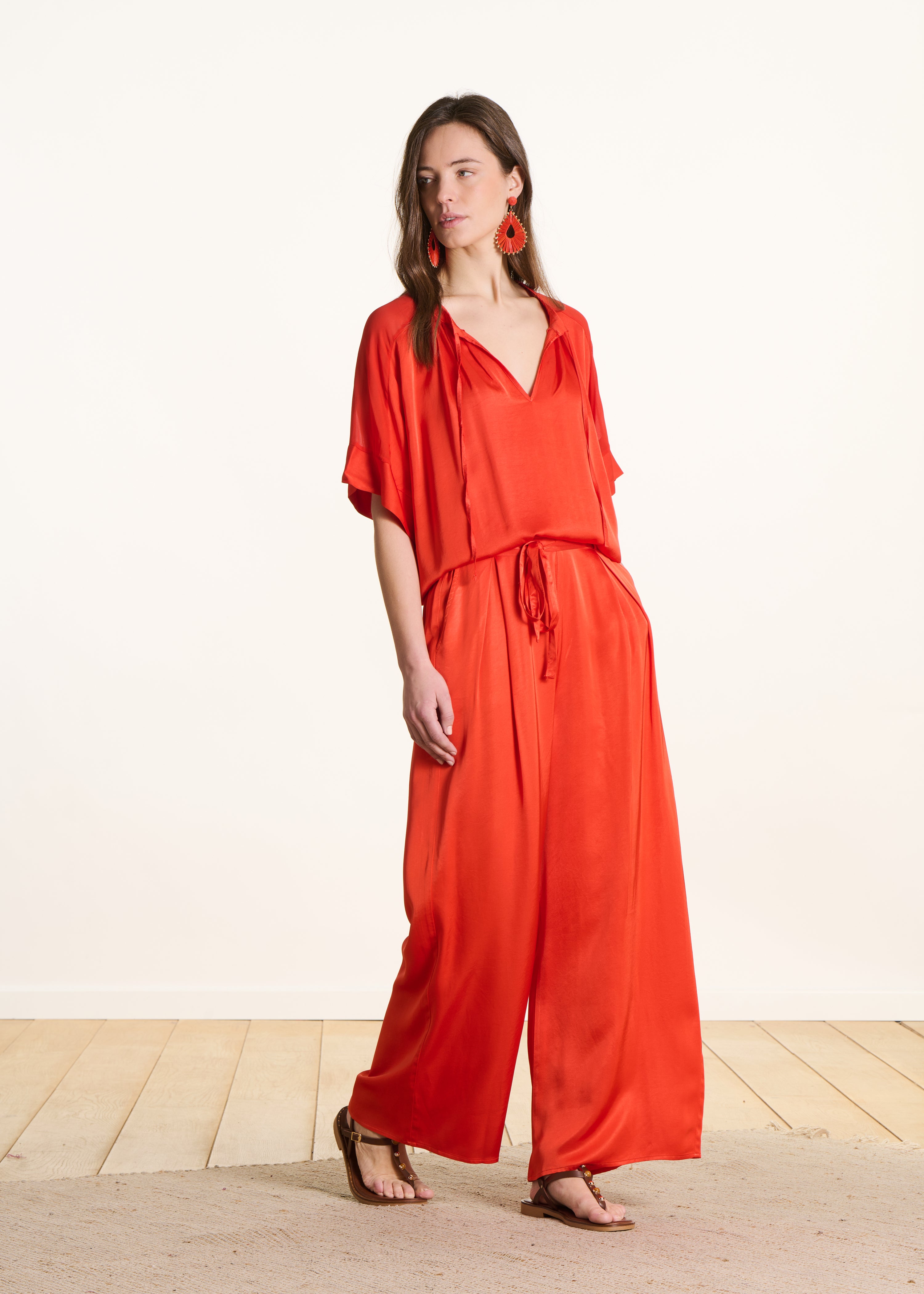 Wide high-waisted orange satin trousers