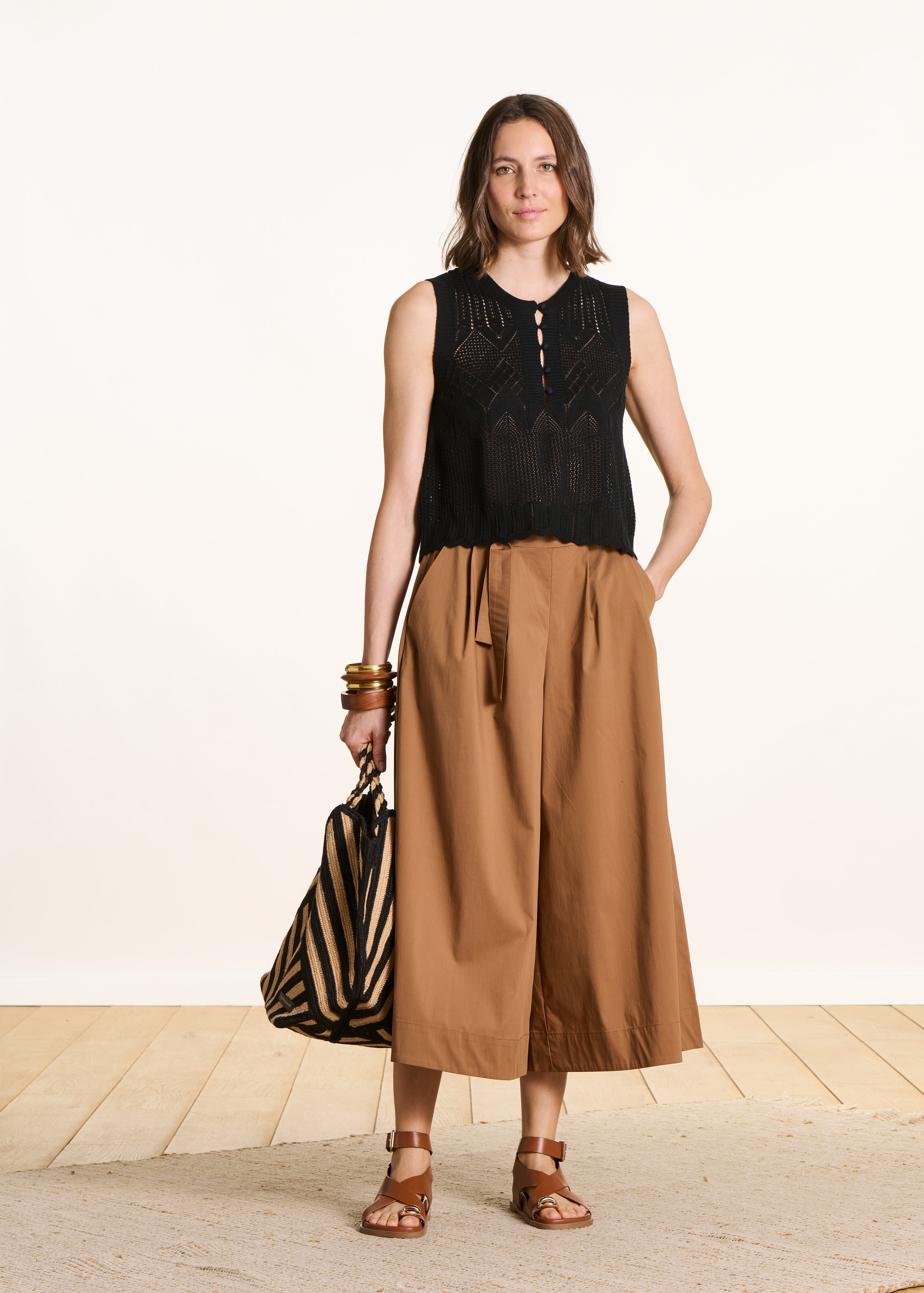 Black sleeveless cropped sweater in pointelle knit