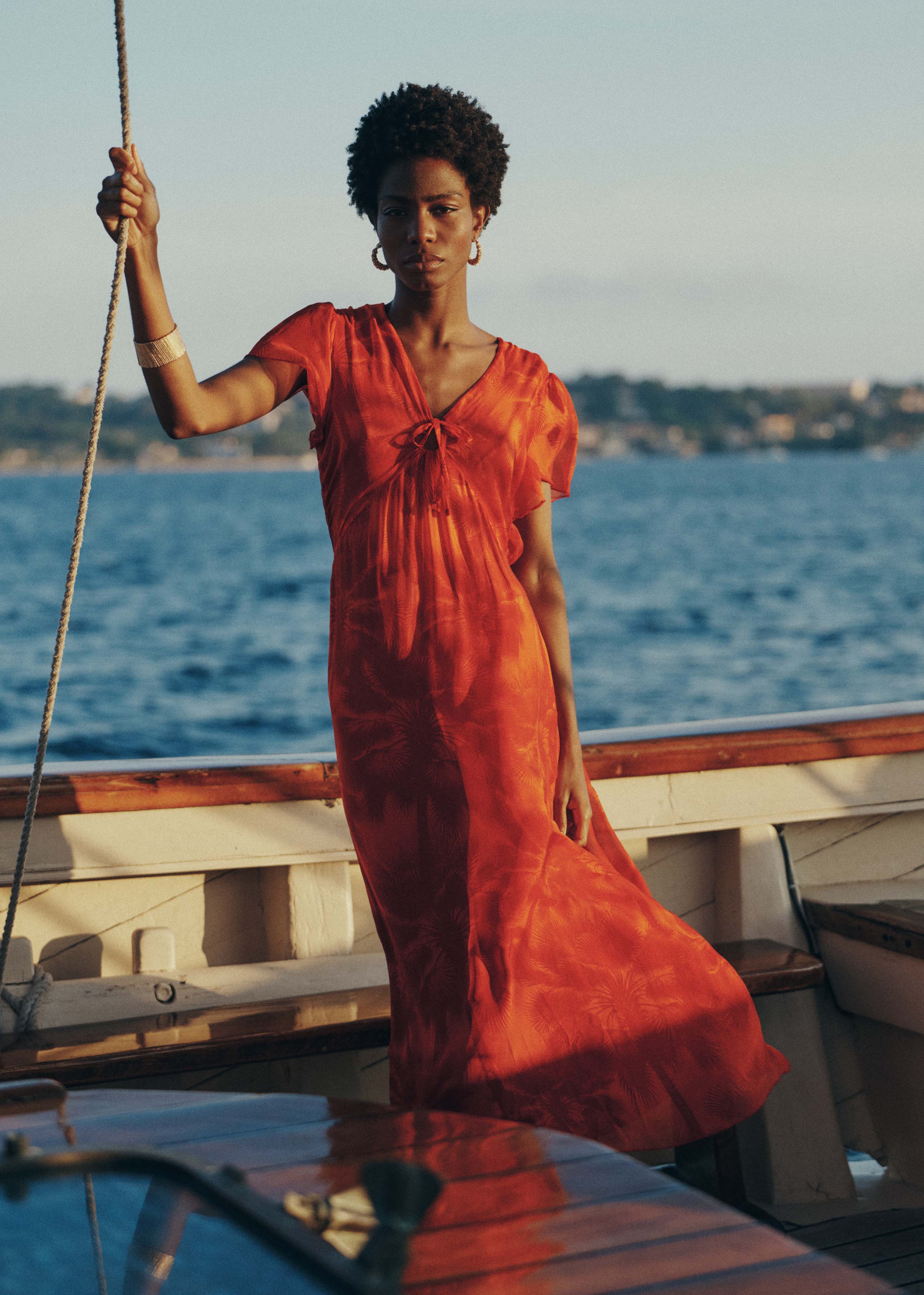 Fitted long orange dress with floral print