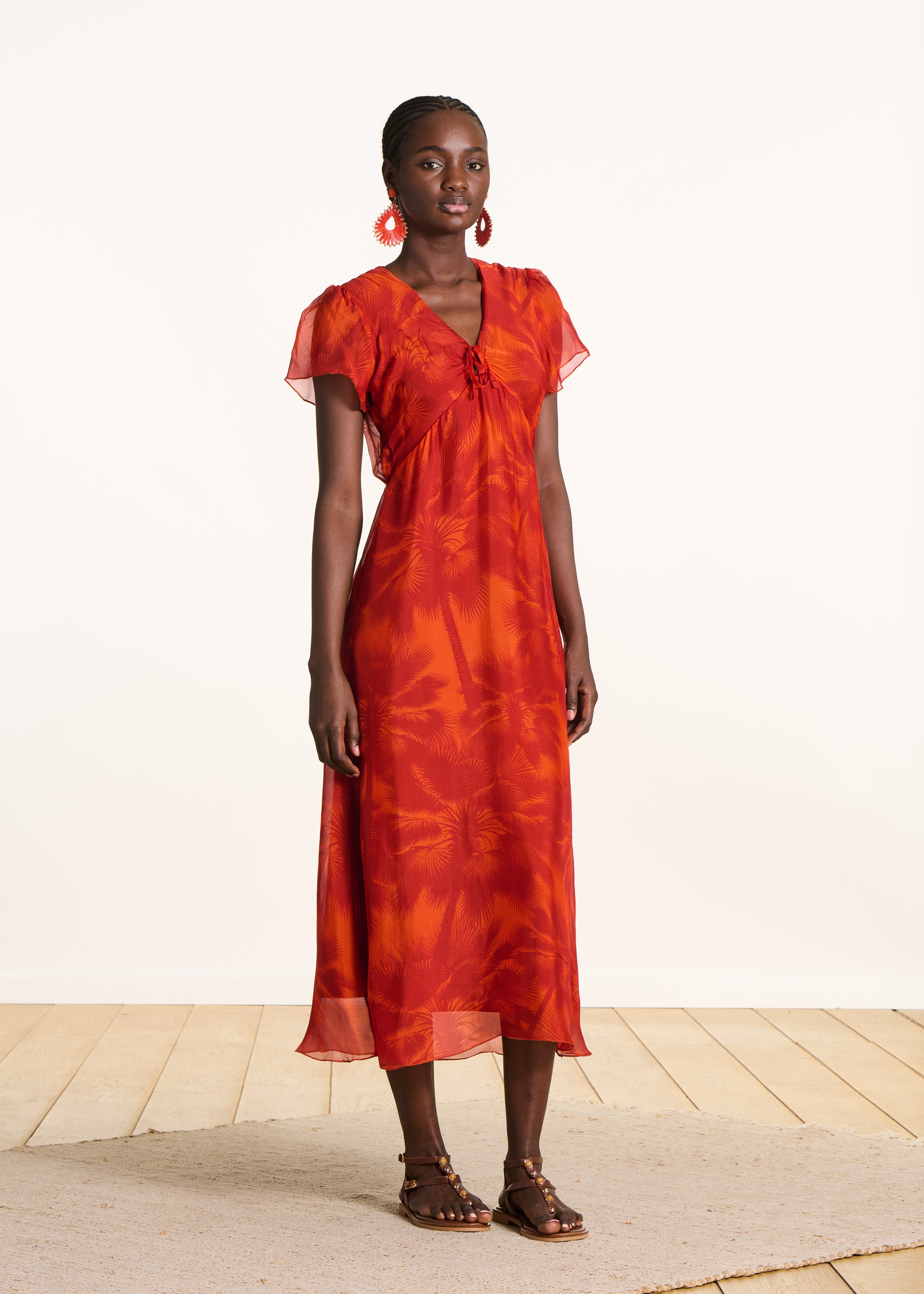Fitted long orange dress with floral print