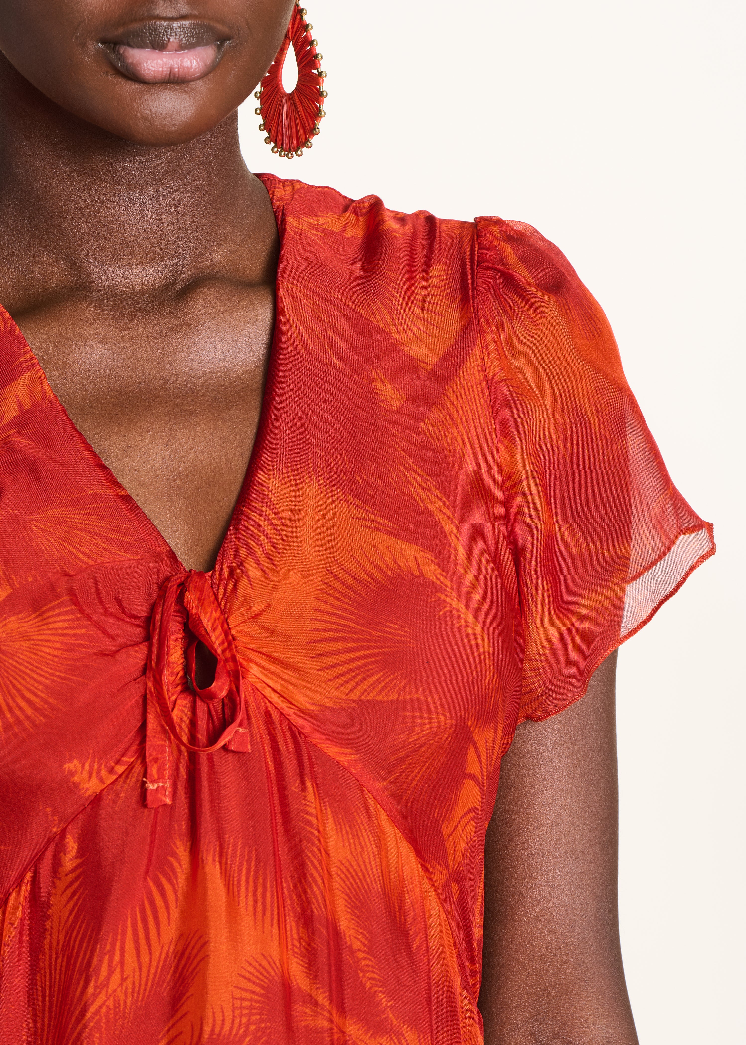 Fitted long orange dress with floral print