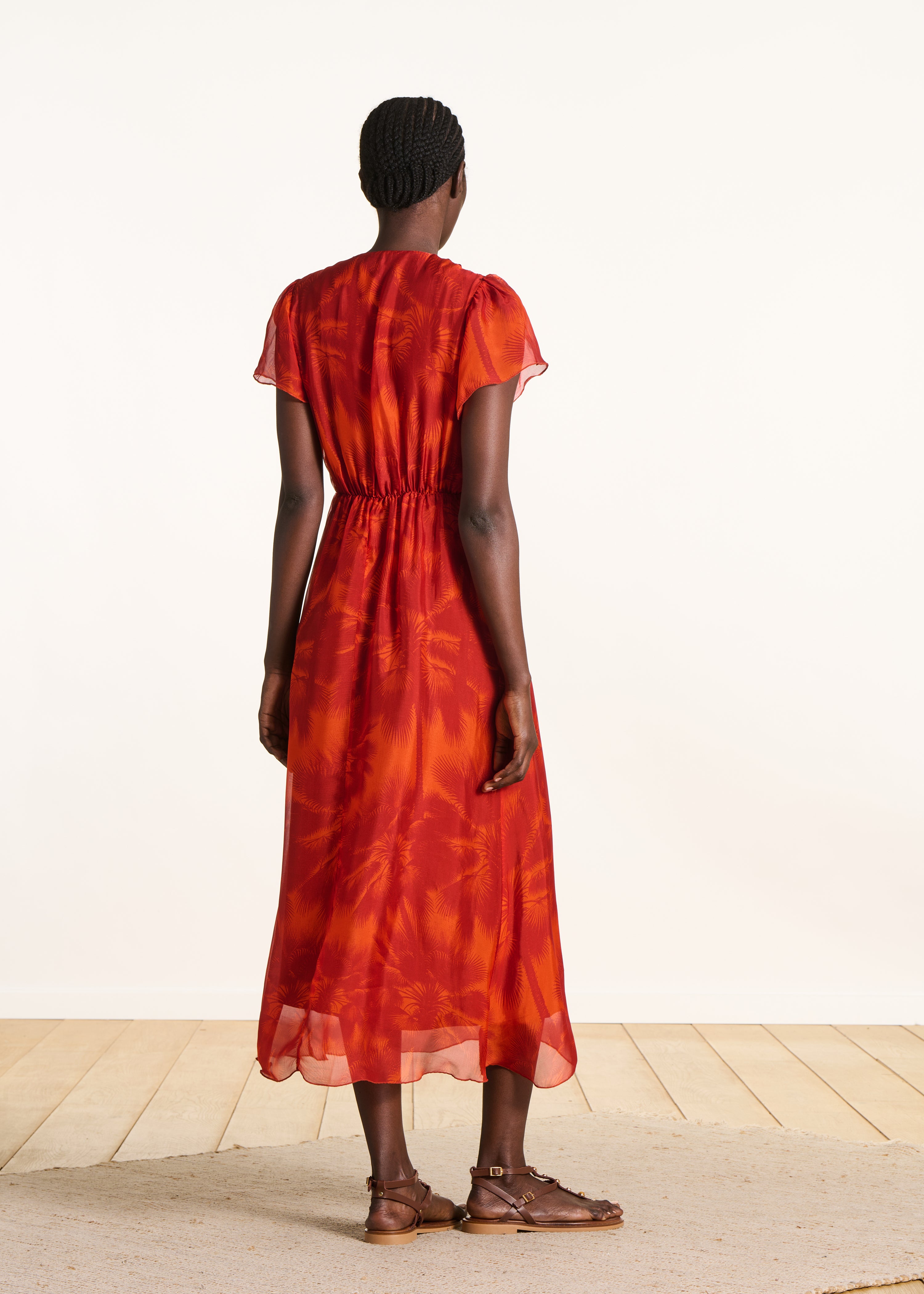 Fitted long orange dress with floral print