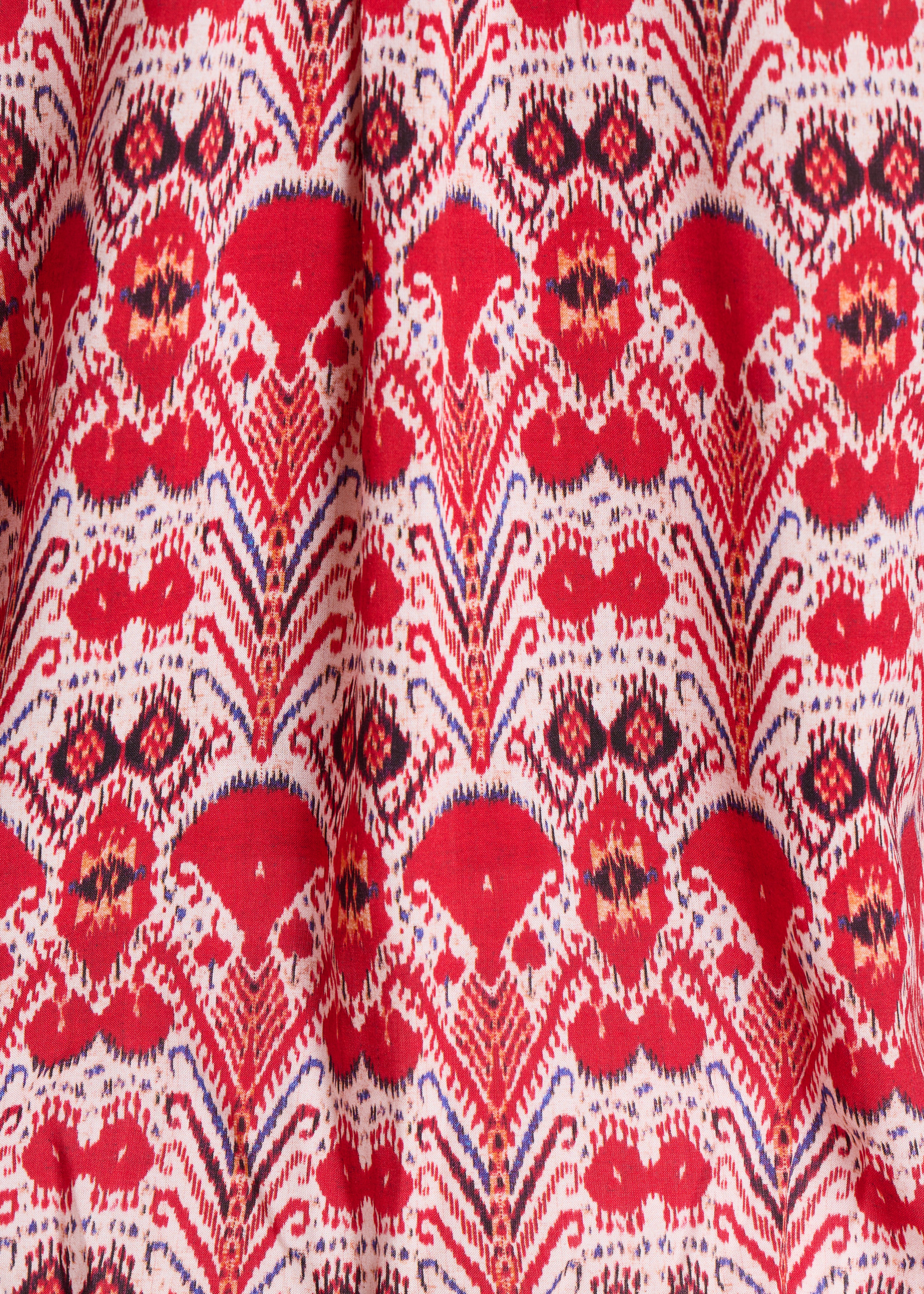 Top vermelho largo com estampado e mangas compridas