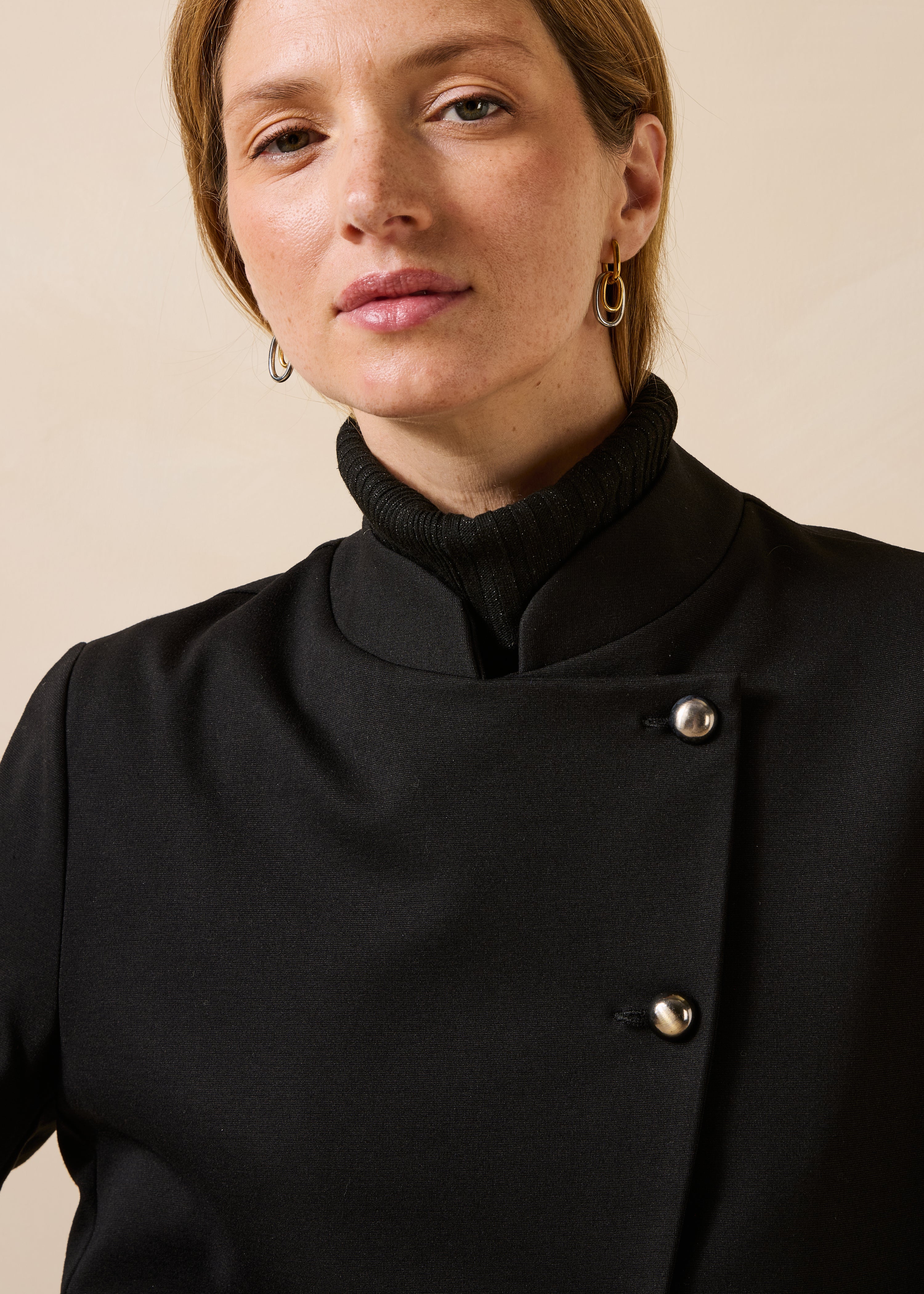 Short black jacket with long sleeves and mandarin collar