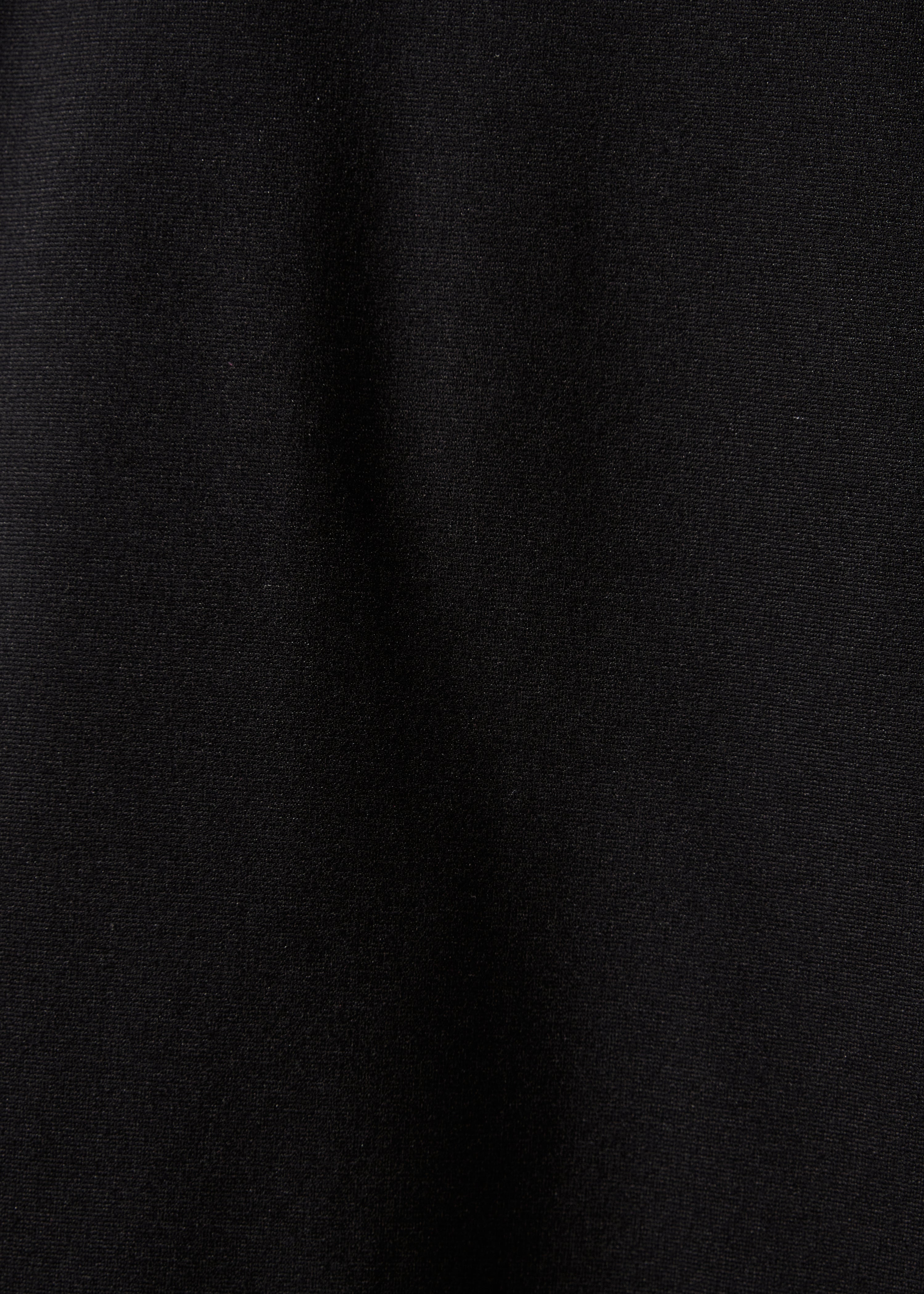 Short black jacket with long sleeves and mandarin collar