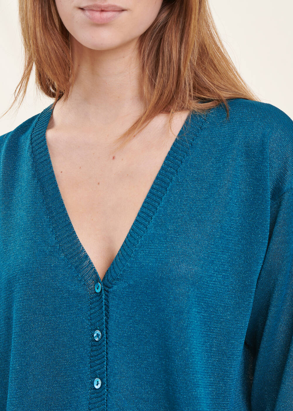 Short petrol blue cardigan with long sleeves and V-neck