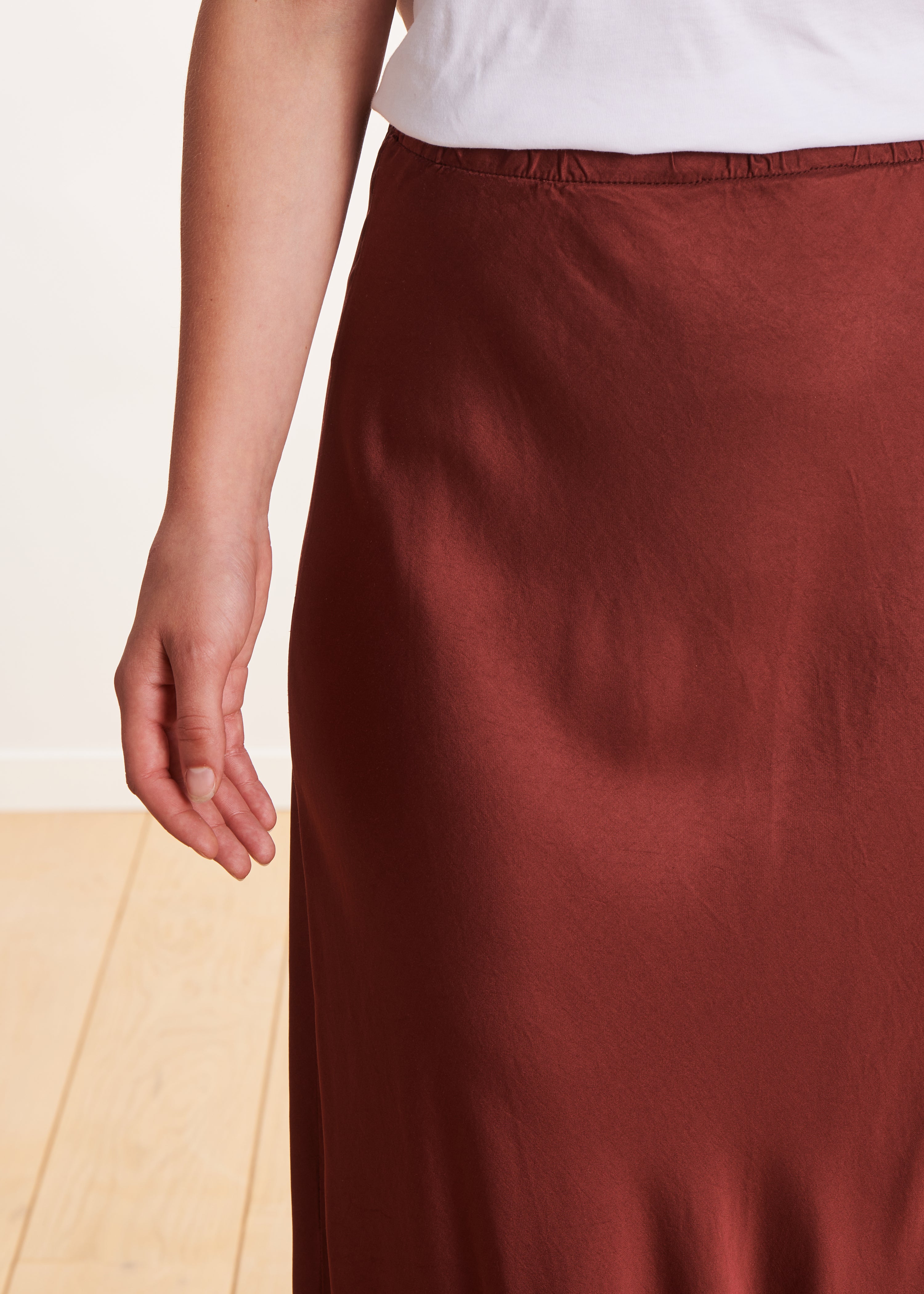 Long flowing burgundy satin skirt