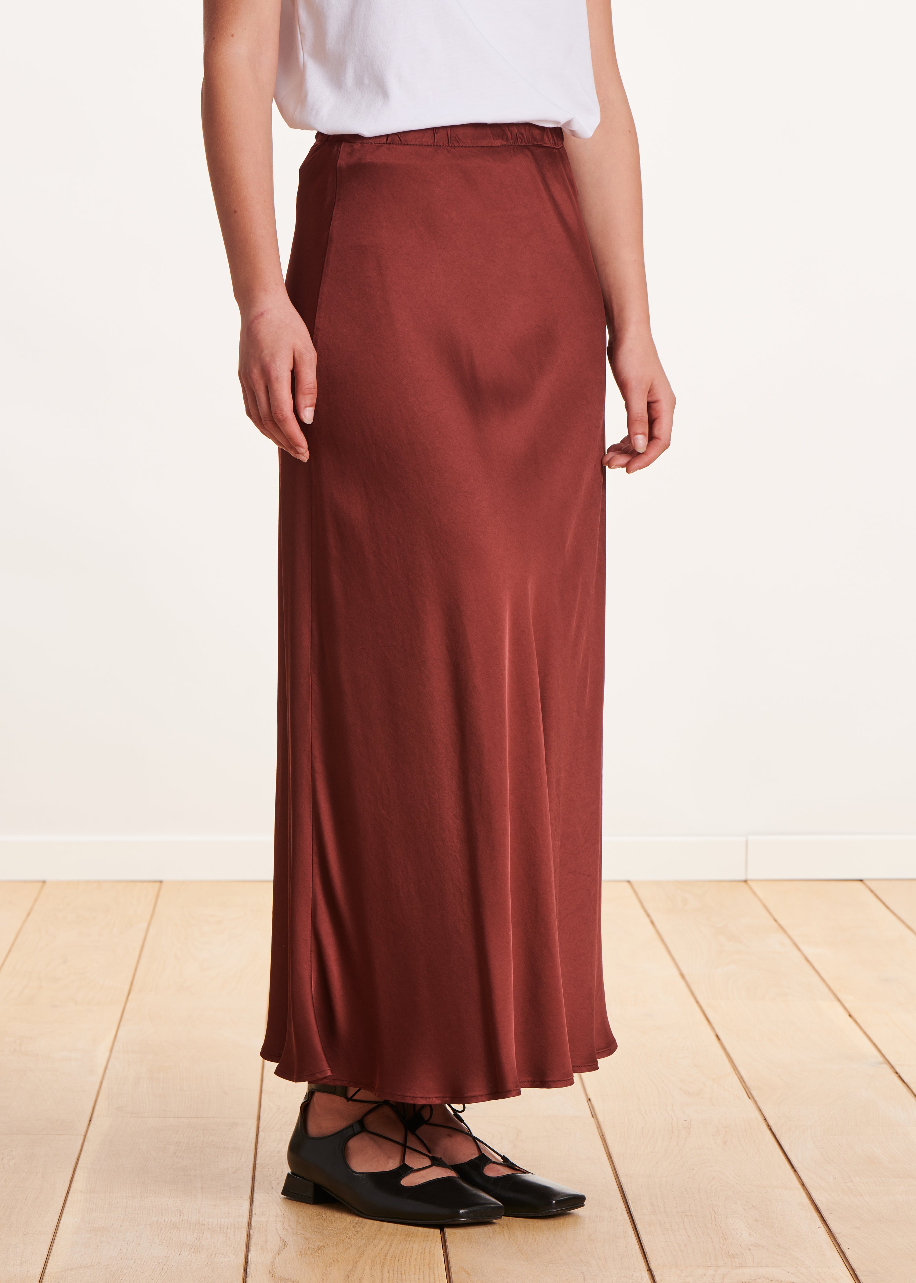 Long flowing burgundy satin skirt