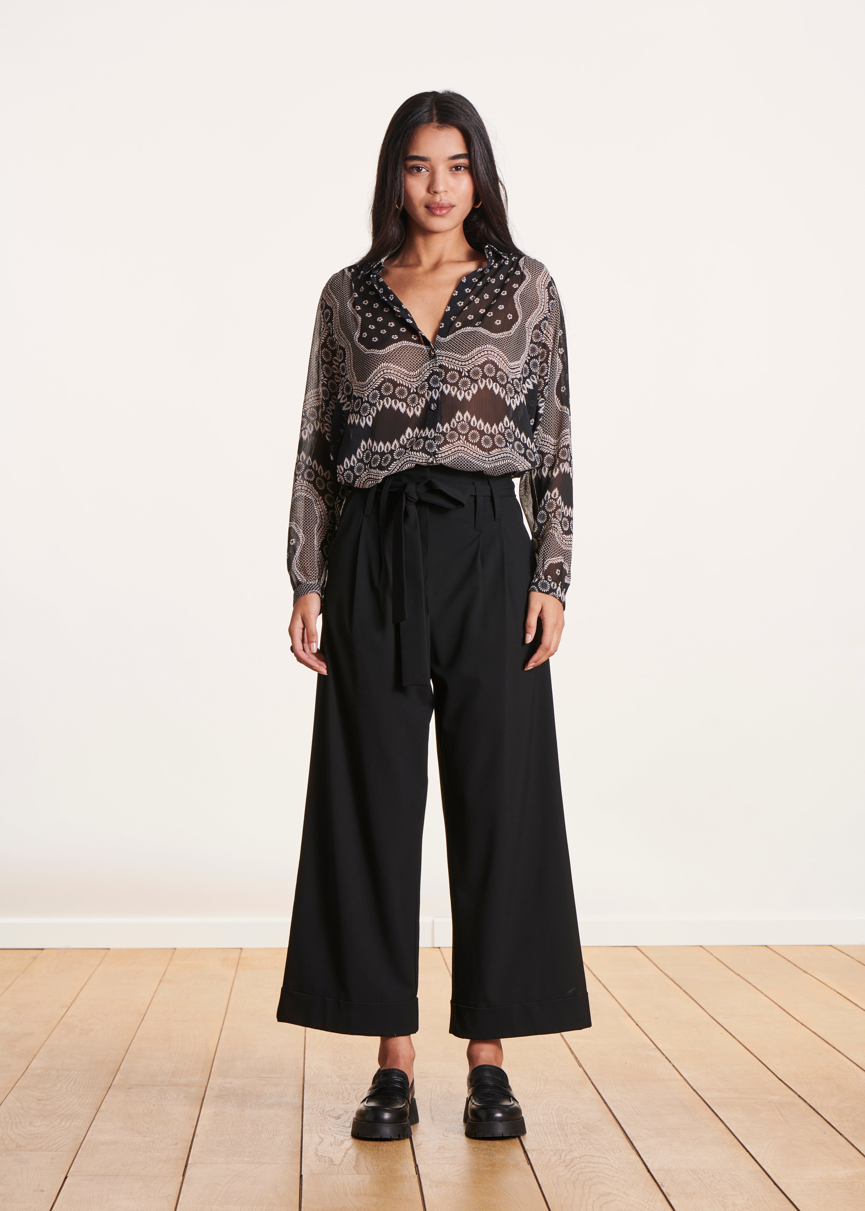 Black high-waisted wide-leg pants with tie belt