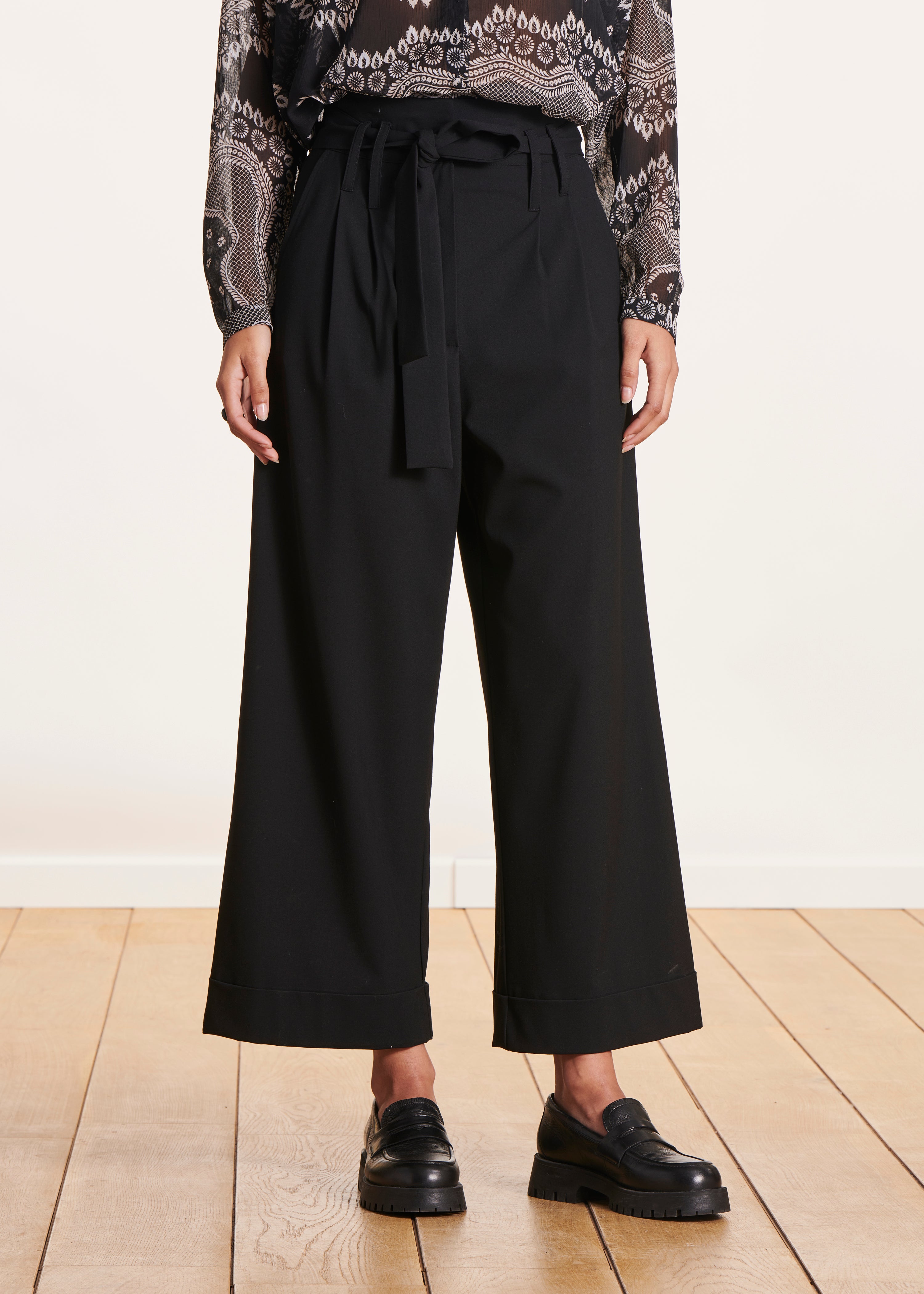 Black high-waisted wide-leg pants with tie belt