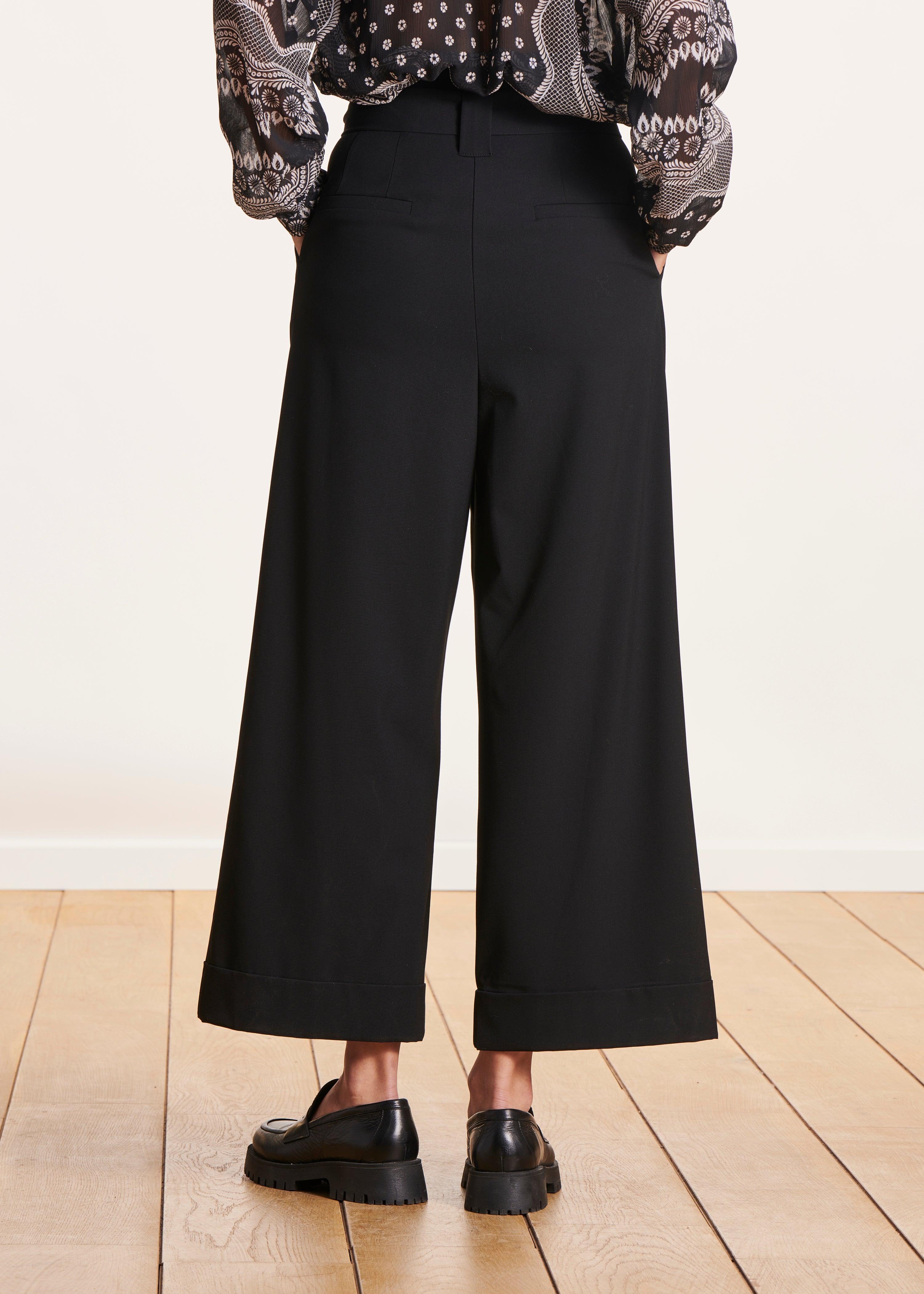 Black high-waisted wide-leg pants with tie belt