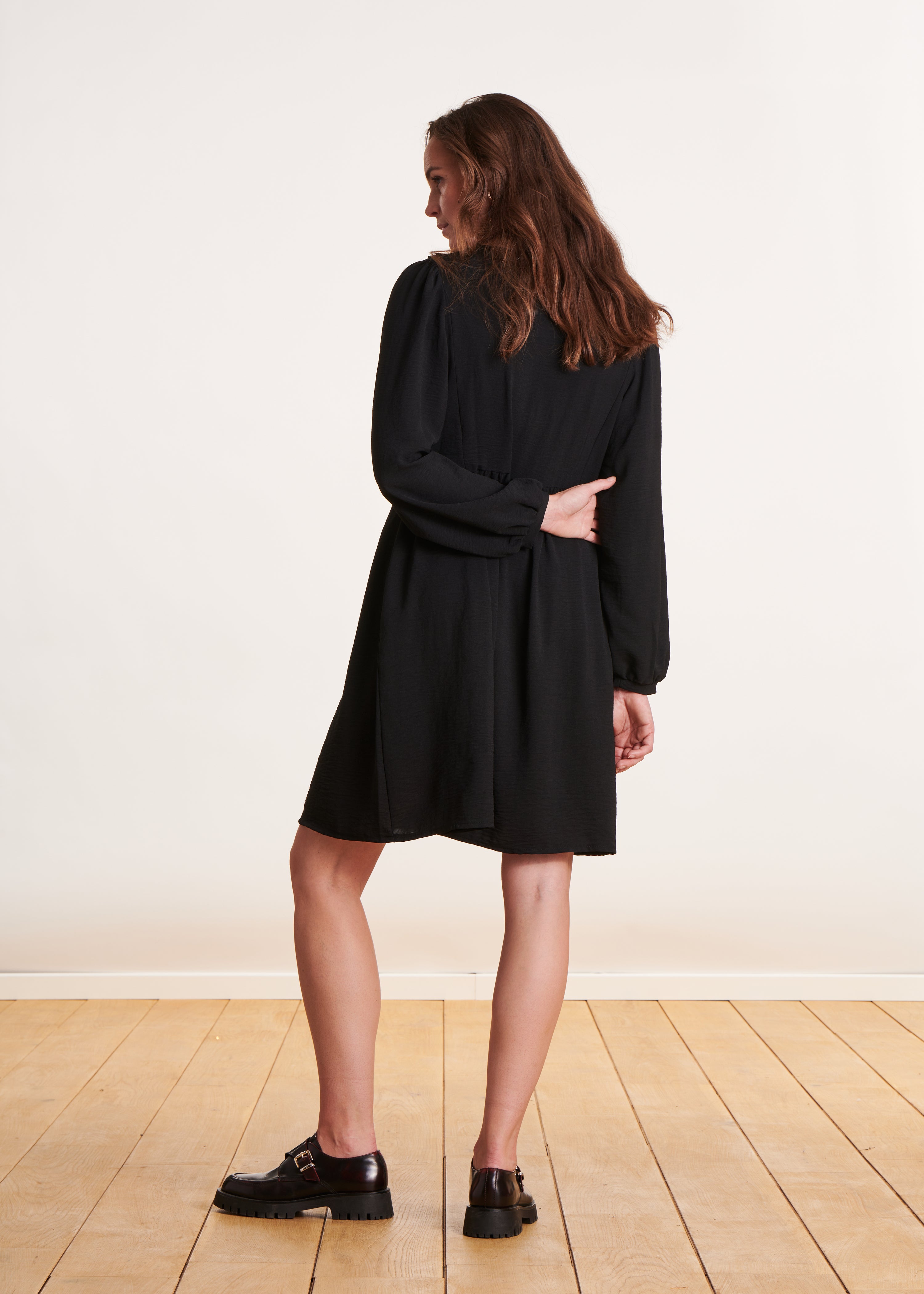 Short, loose-fitting black dress