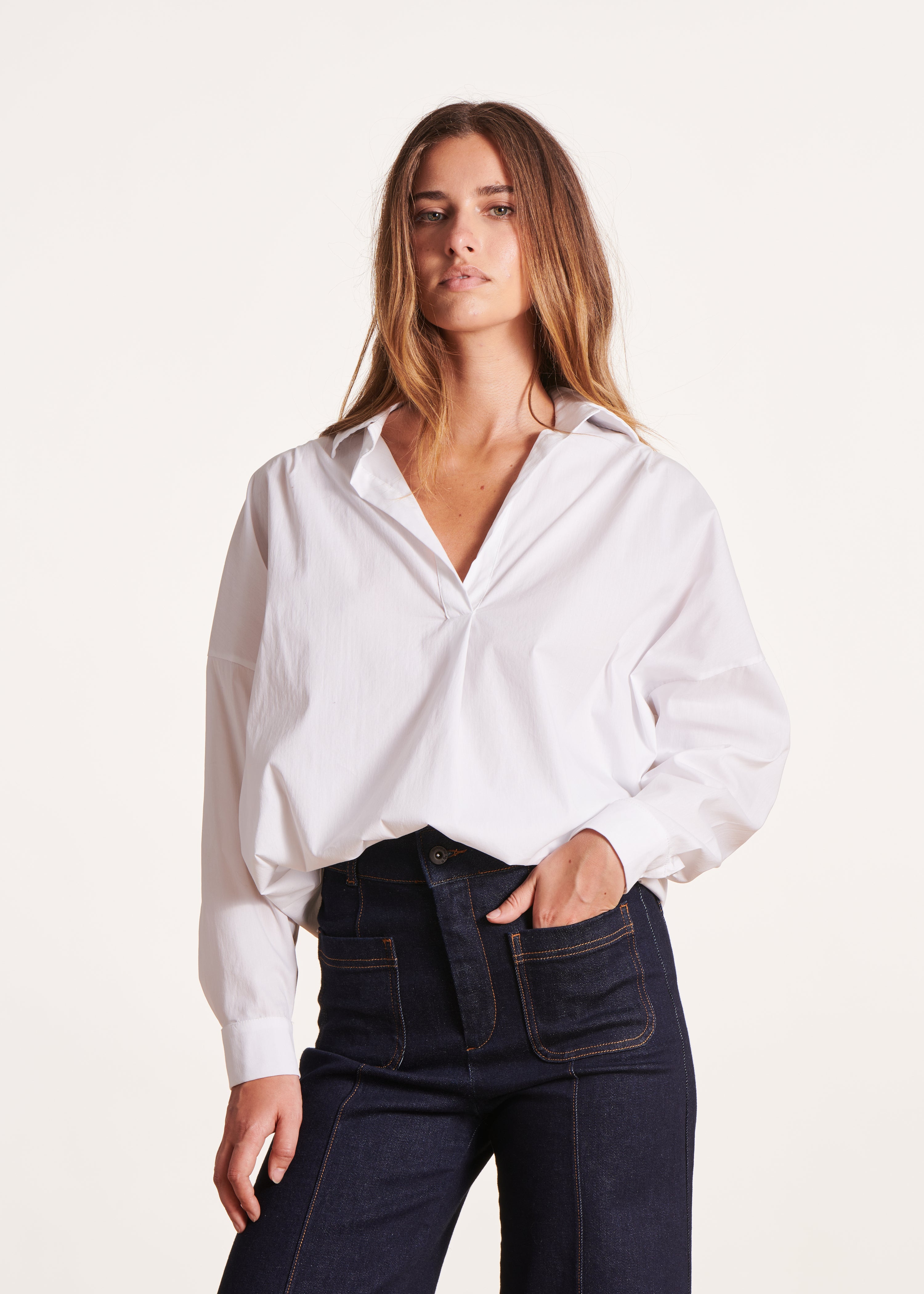 Loose white blouse with long sleeves