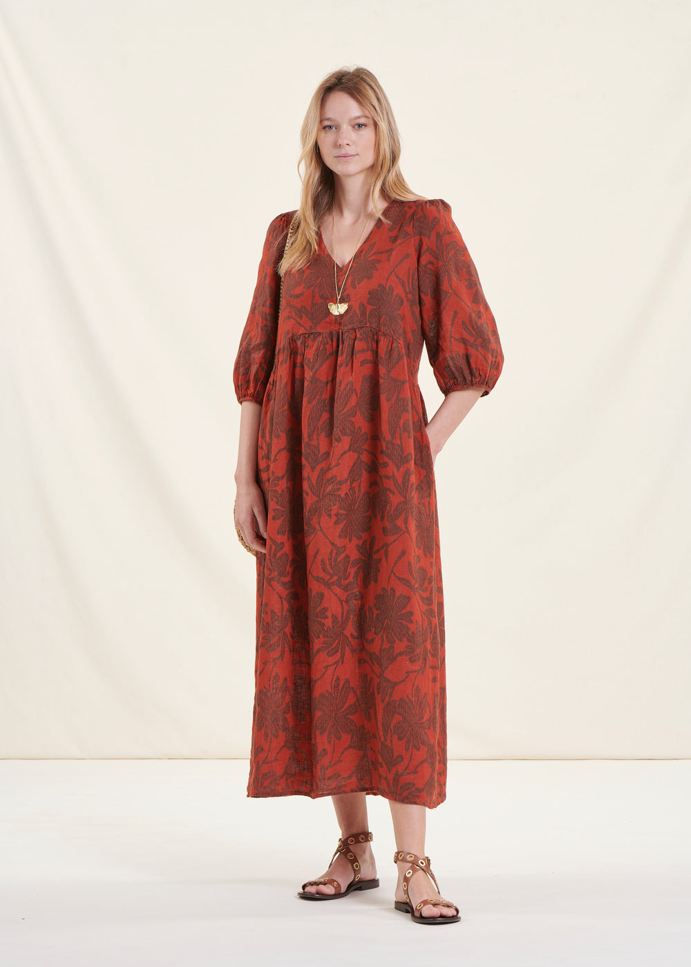 Bohemian orange linen mid-length dress with 3/4 sleeves and floral print