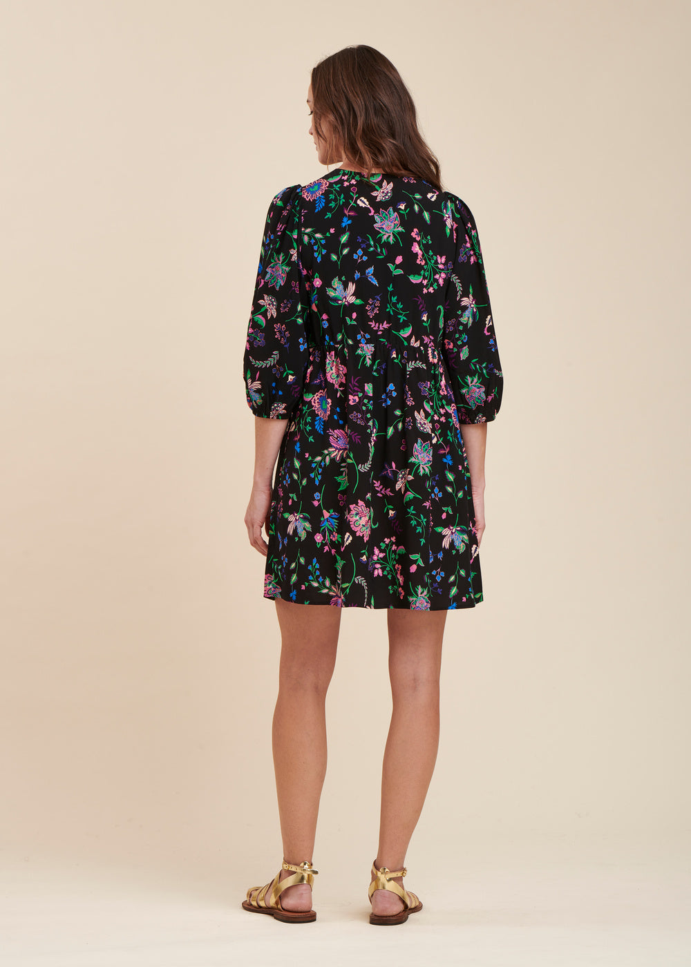 Short black fitted dress with 3/4 floral sleeves and V-neck