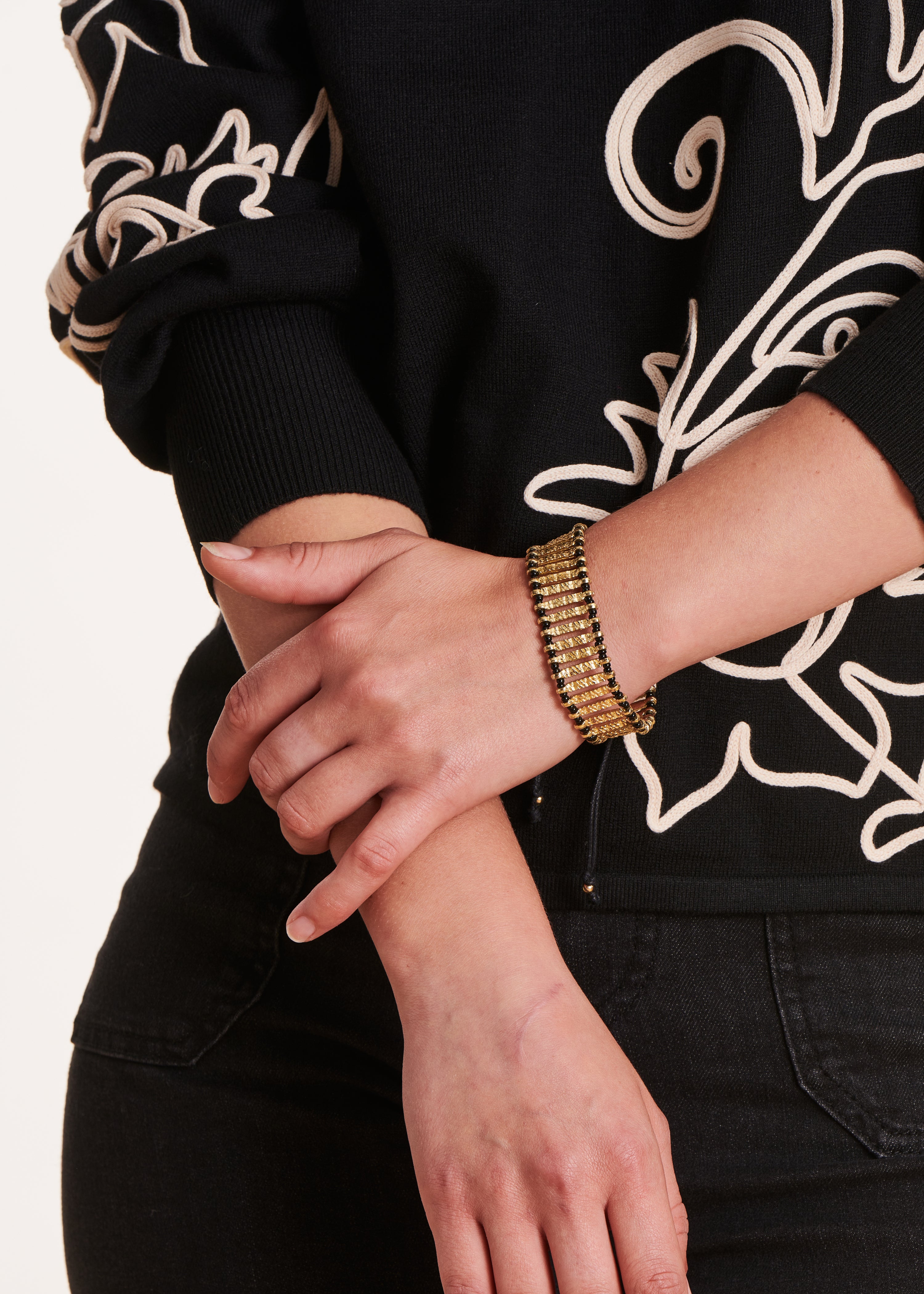 Wide gold bracelet with black links