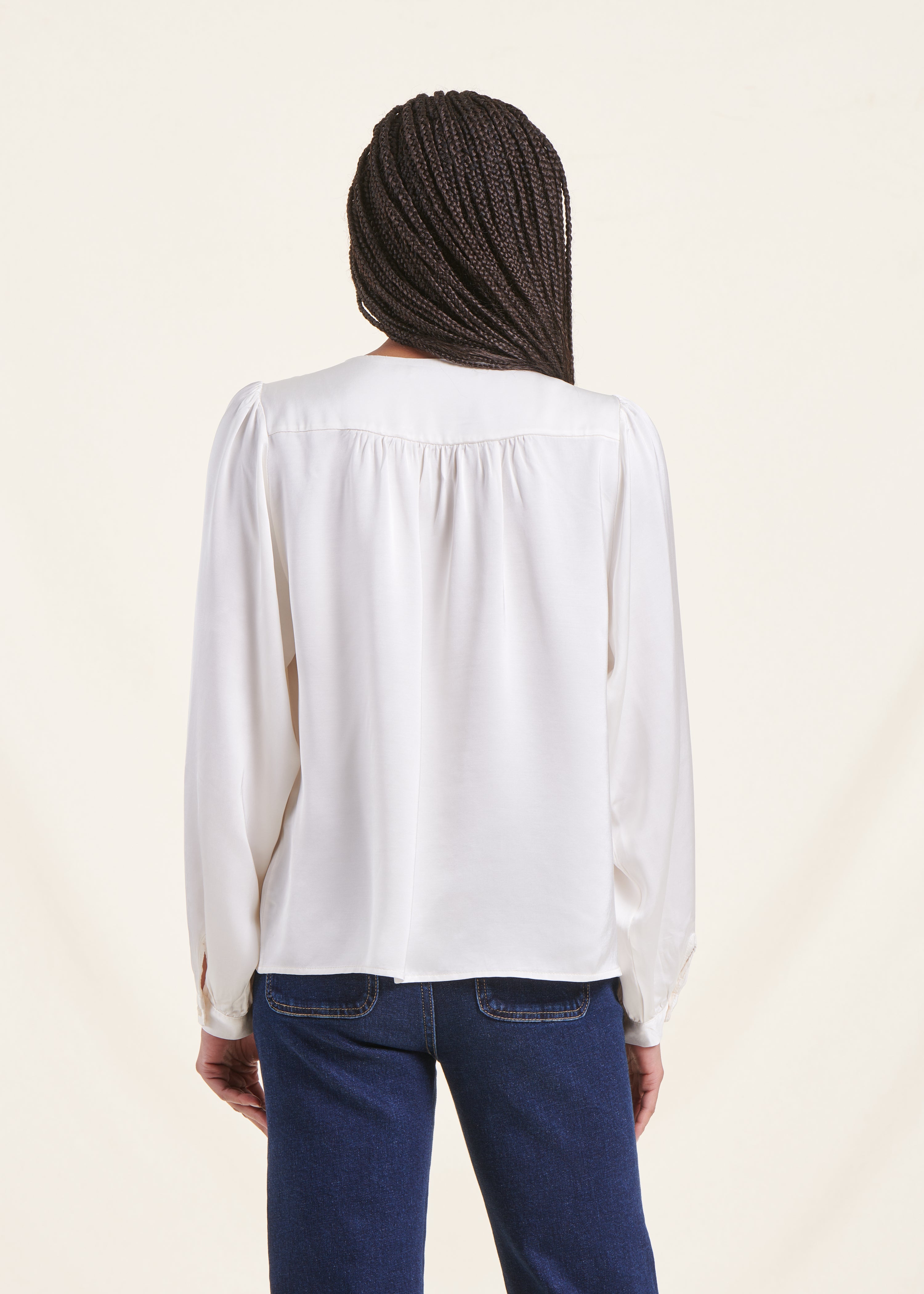 Loose white satin blouse with round neckline