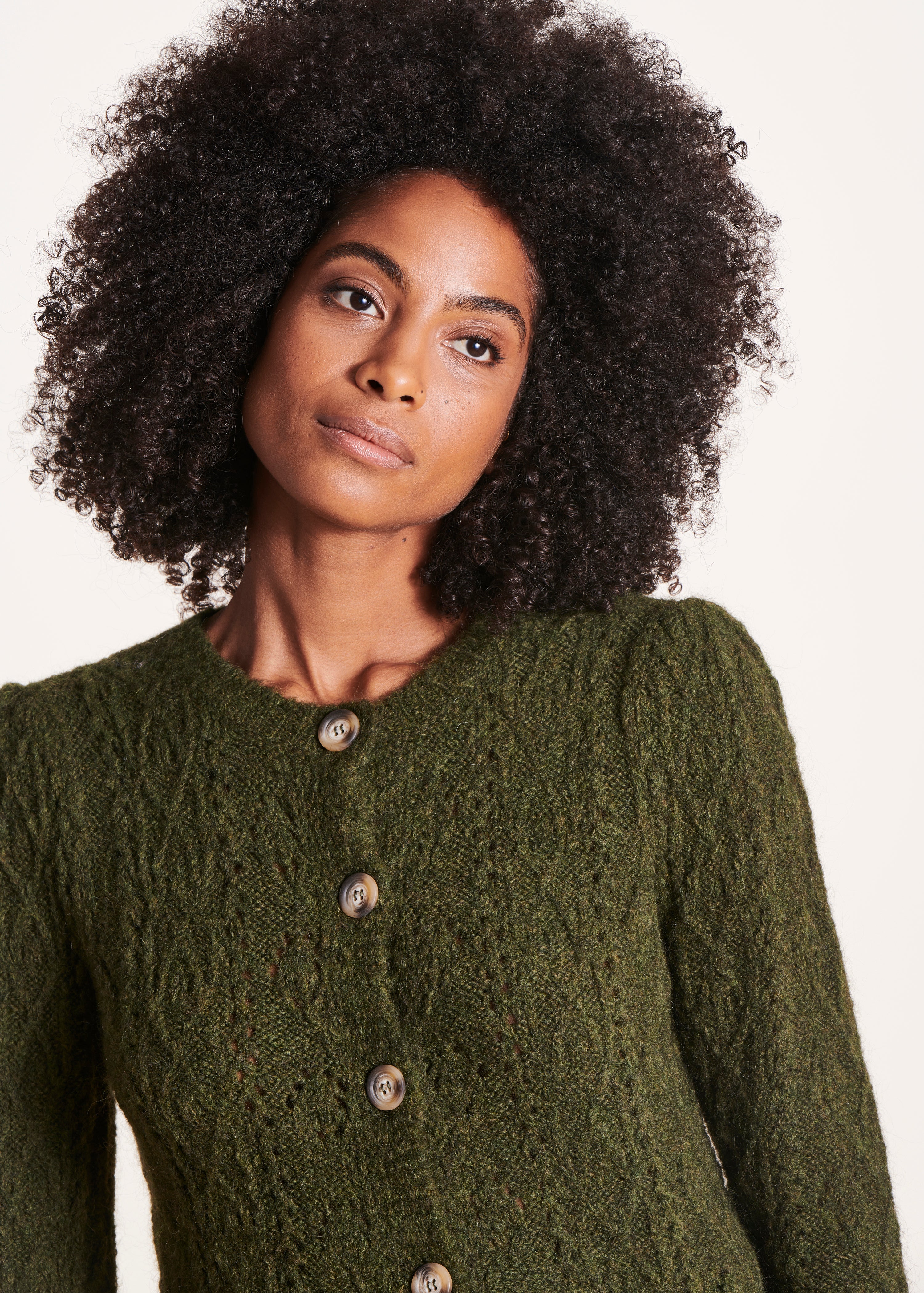 Green cardigan with round neckline and long sleeves