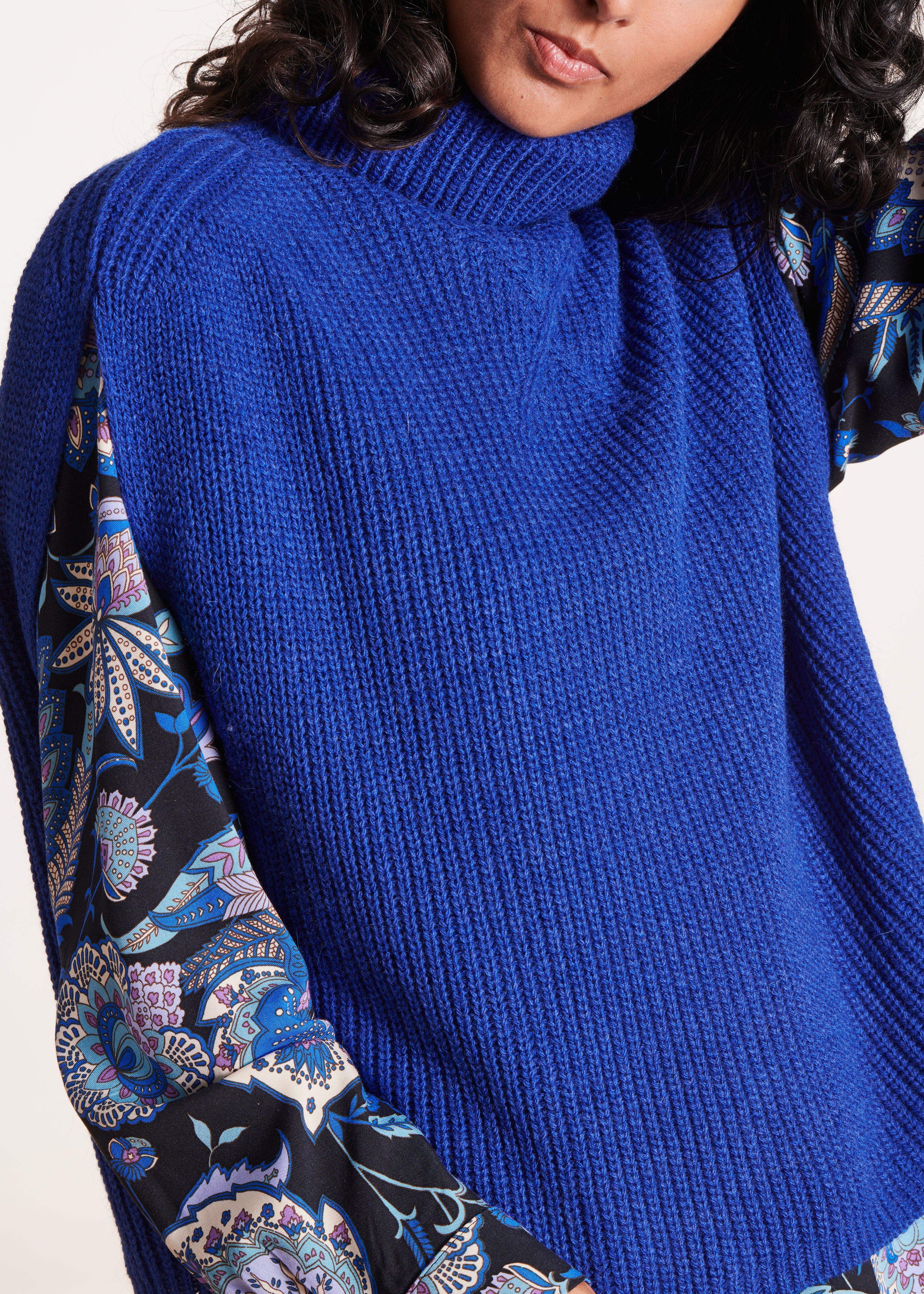 Blue sleeveless turtleneck sweater