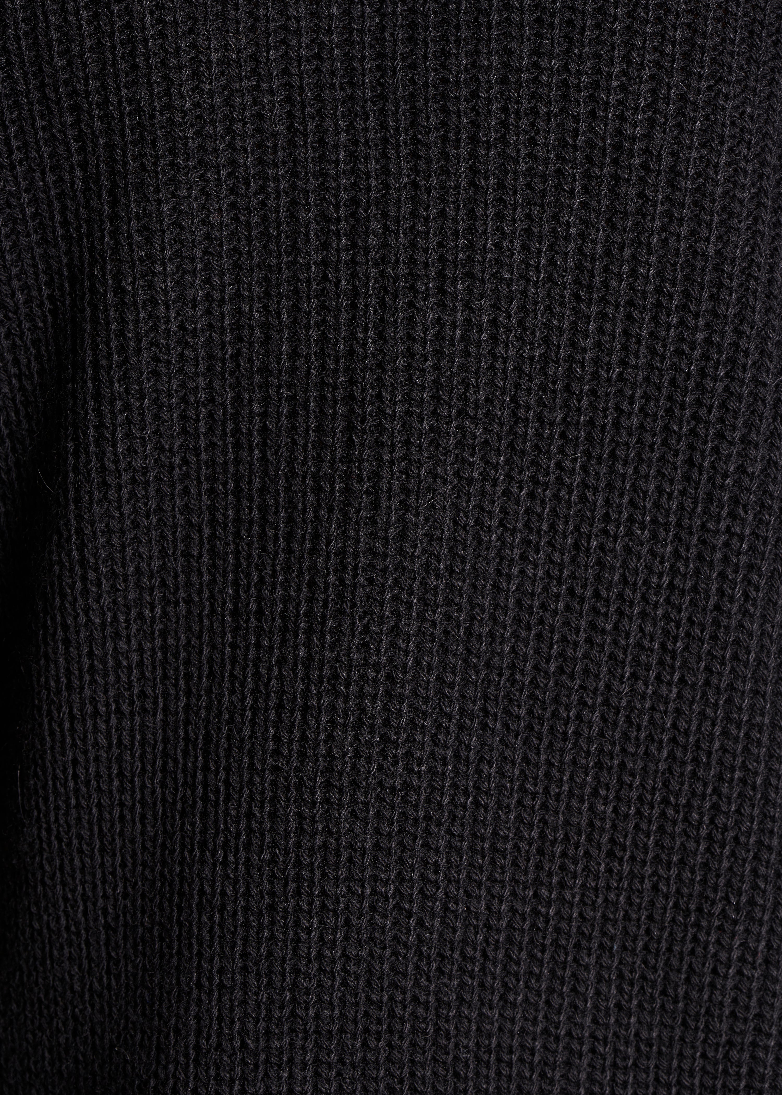 Loose black sweater with ball neck in pearl ribbing