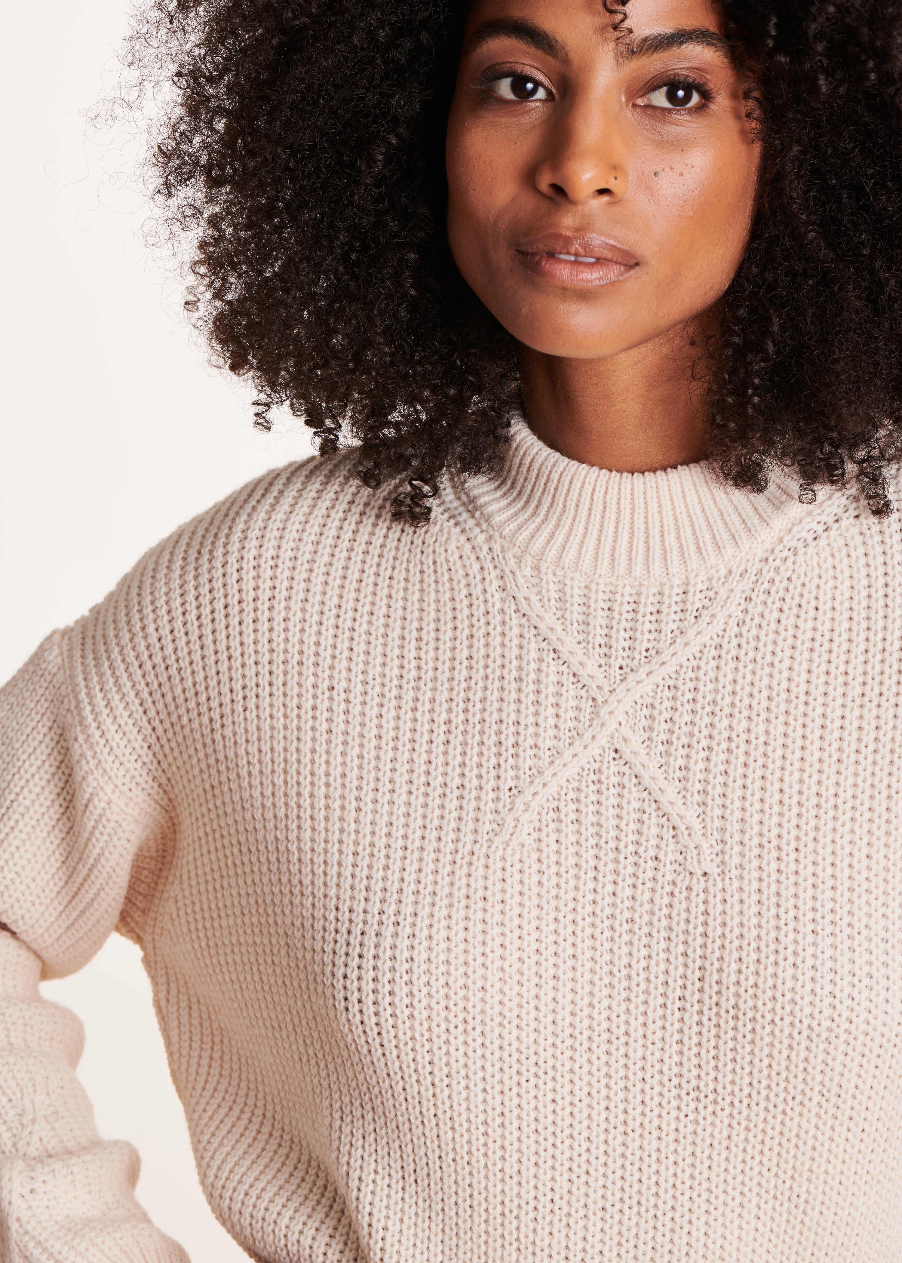 Ecru sweater with high collar in beaded rib knit