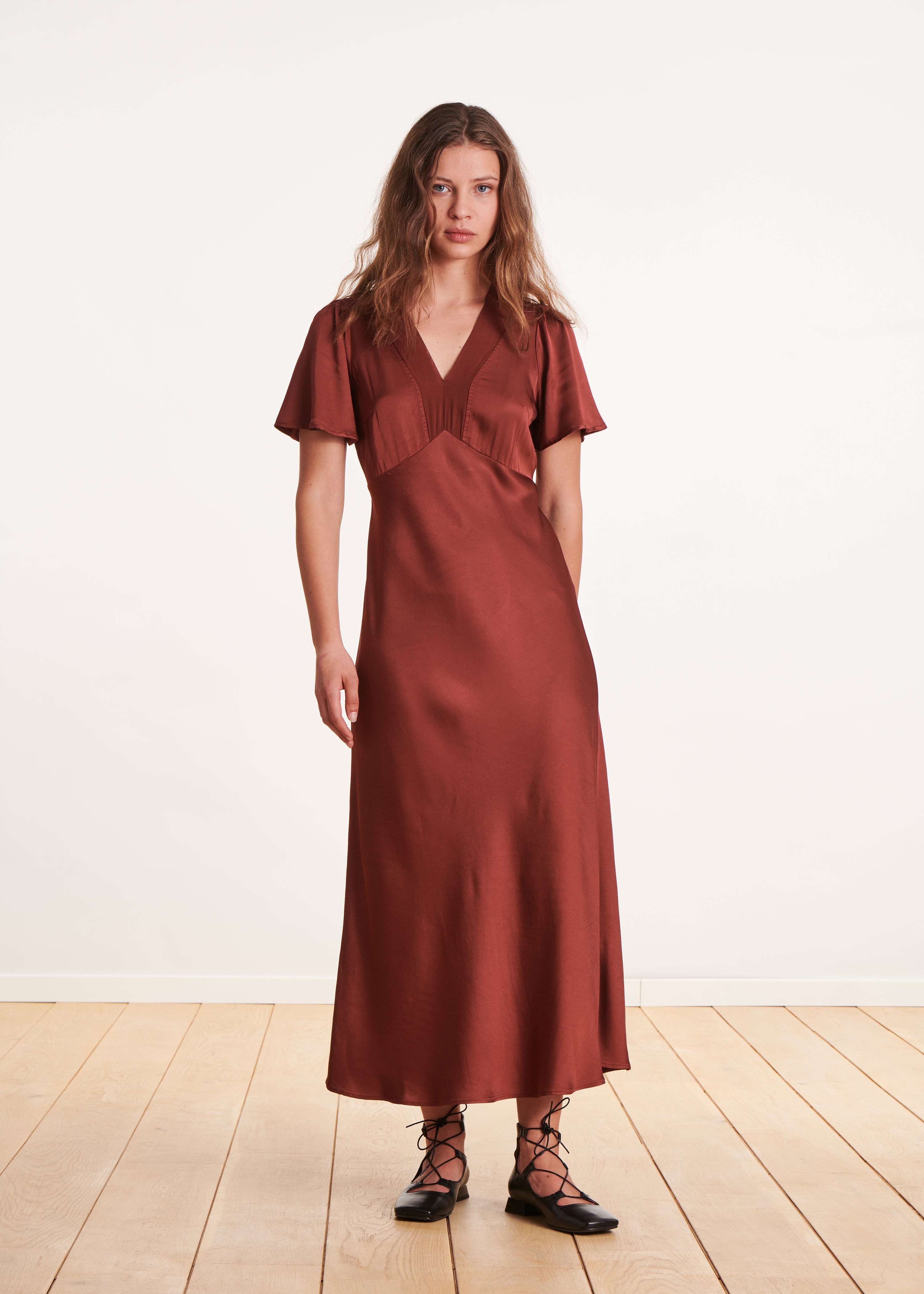 Long flowing burgundy fitted dress with short sleeves