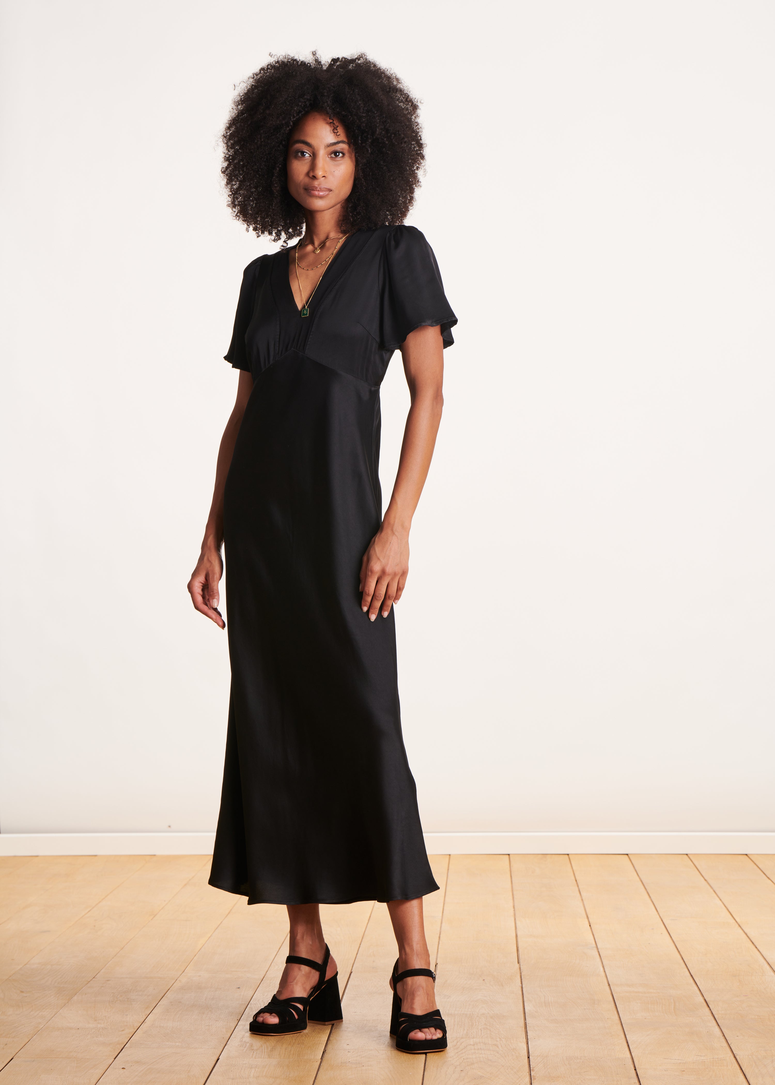 Long black flowing fitted dress with short sleeves