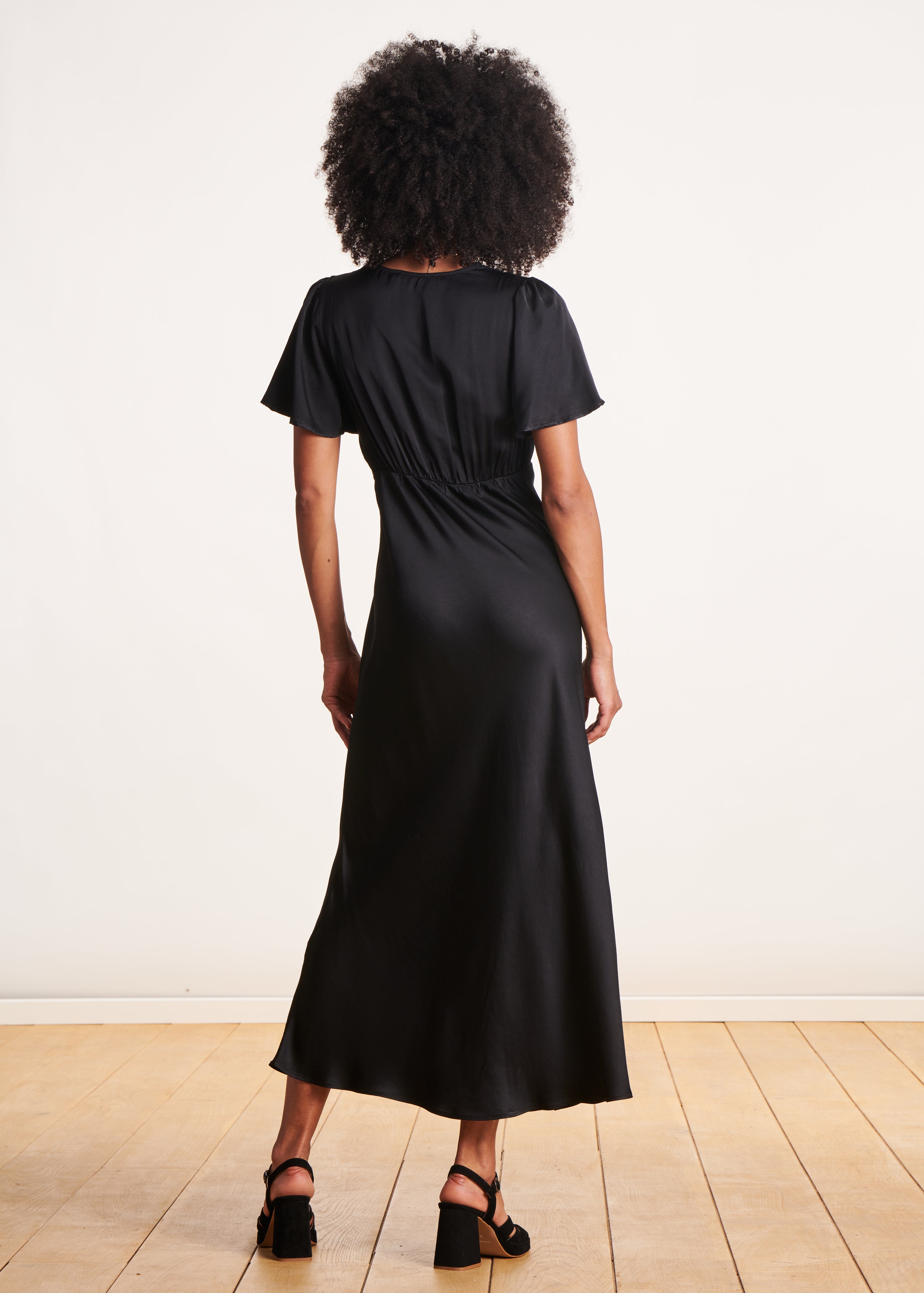 Long black flowing fitted dress with short sleeves