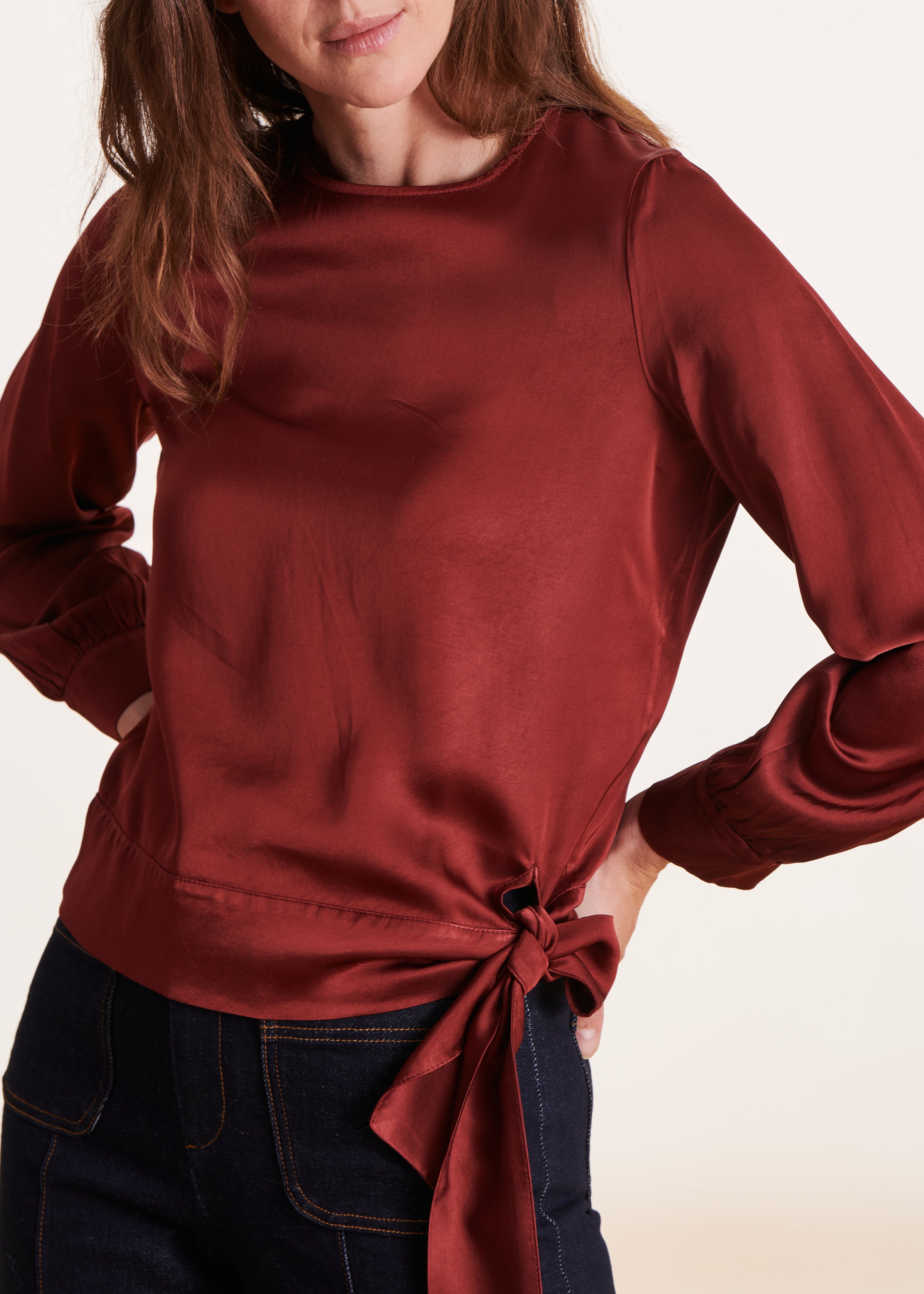 Loose and flowing burgundy top with long sleeves