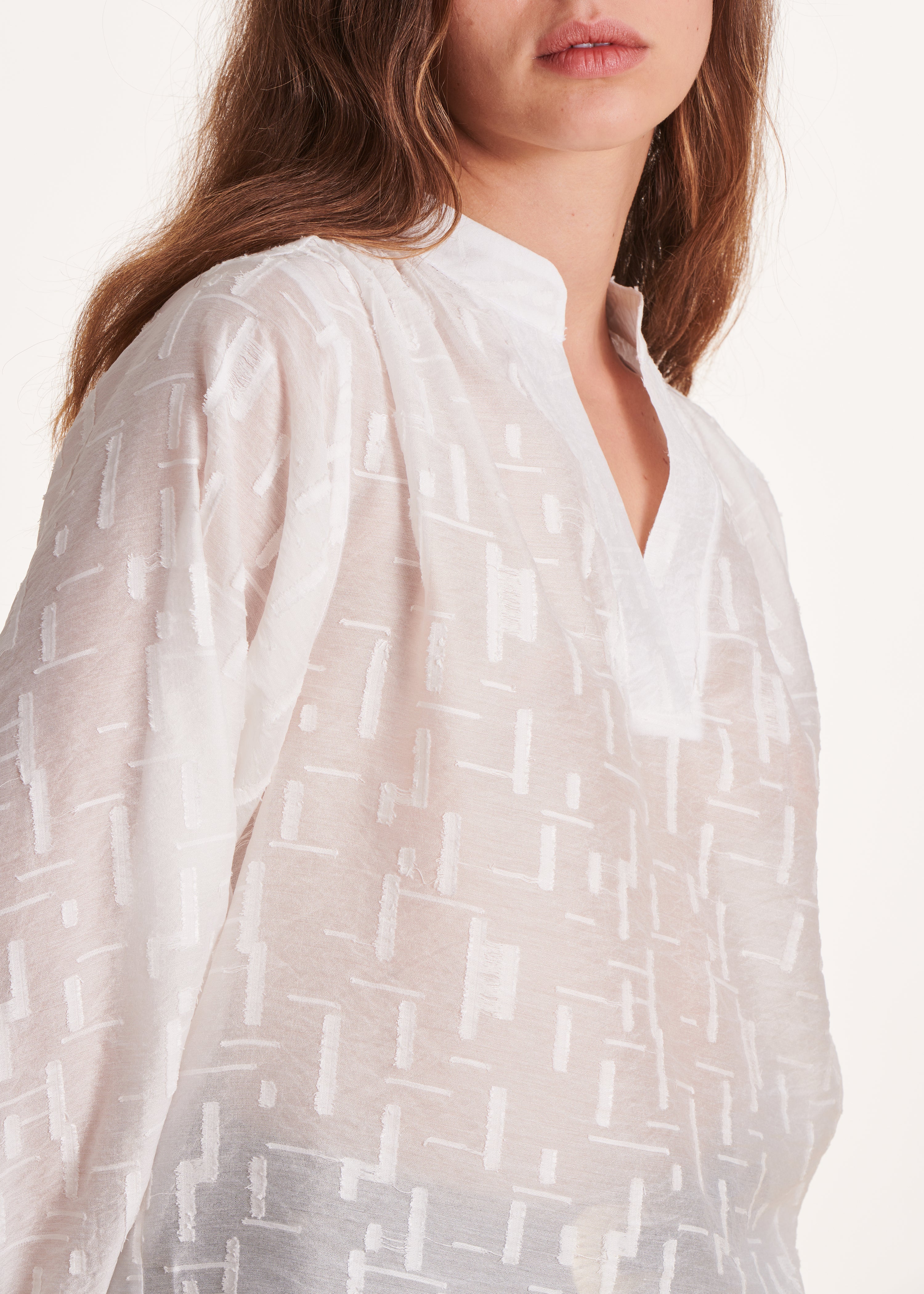 Loose-fitting long-sleeved white voile top