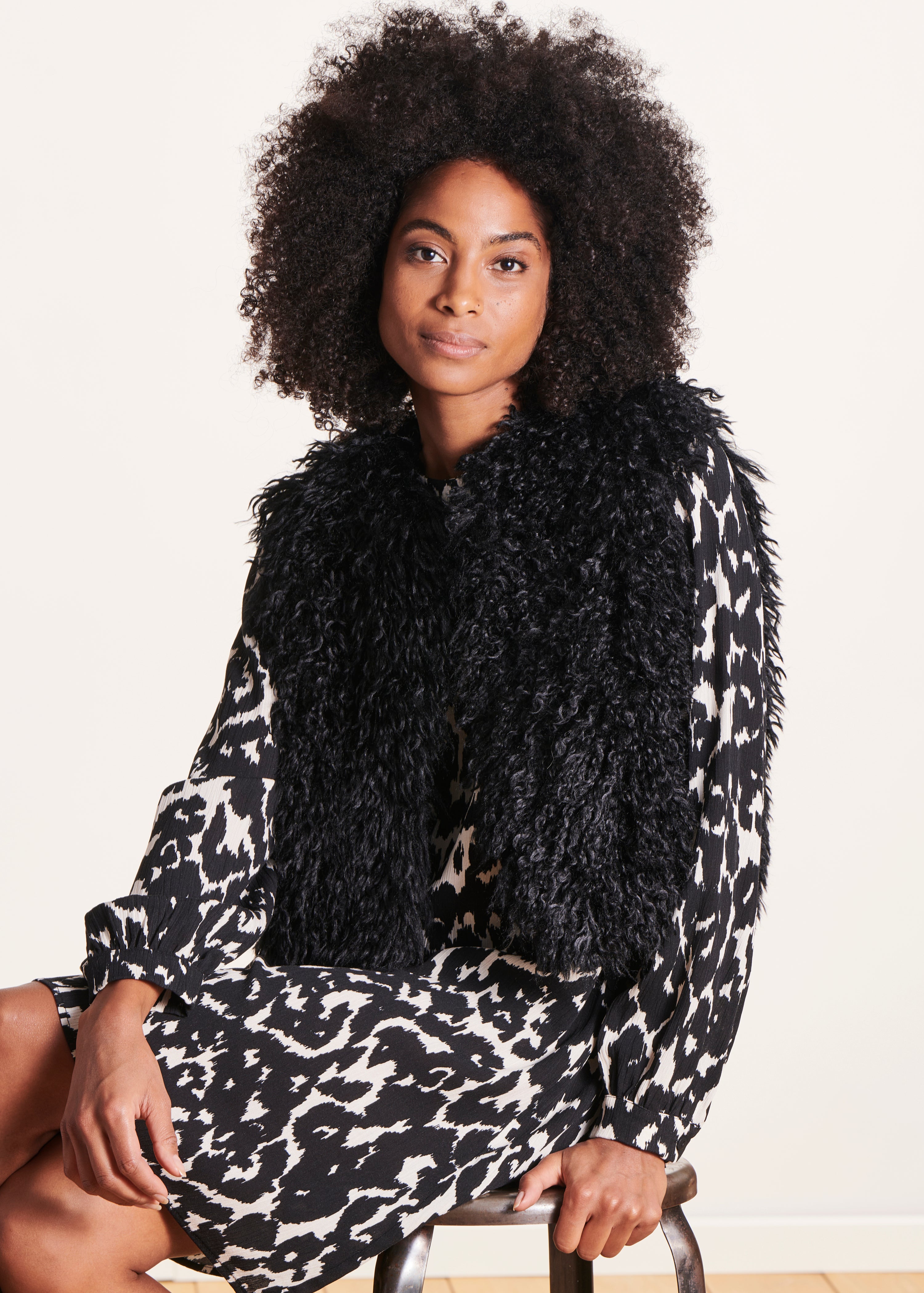 Black sleeveless boucle jacket