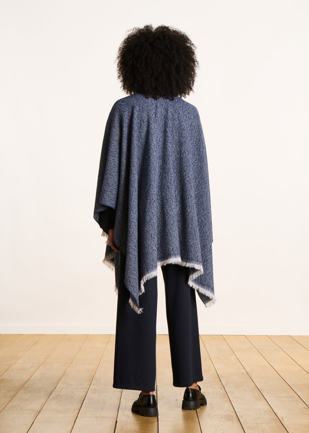 Blue denim poncho with fringes