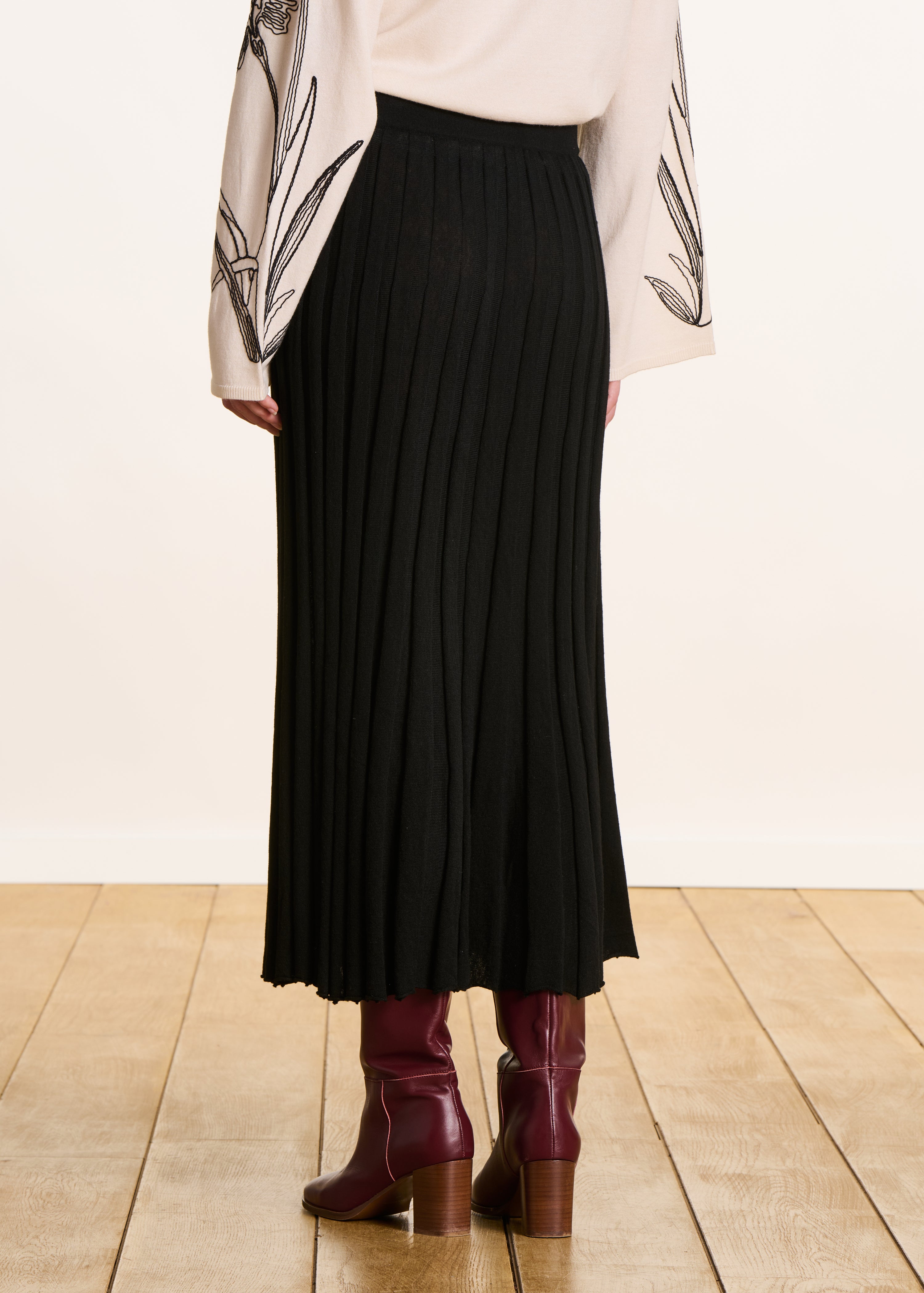 Jupe mi-longue noire en maille plissée