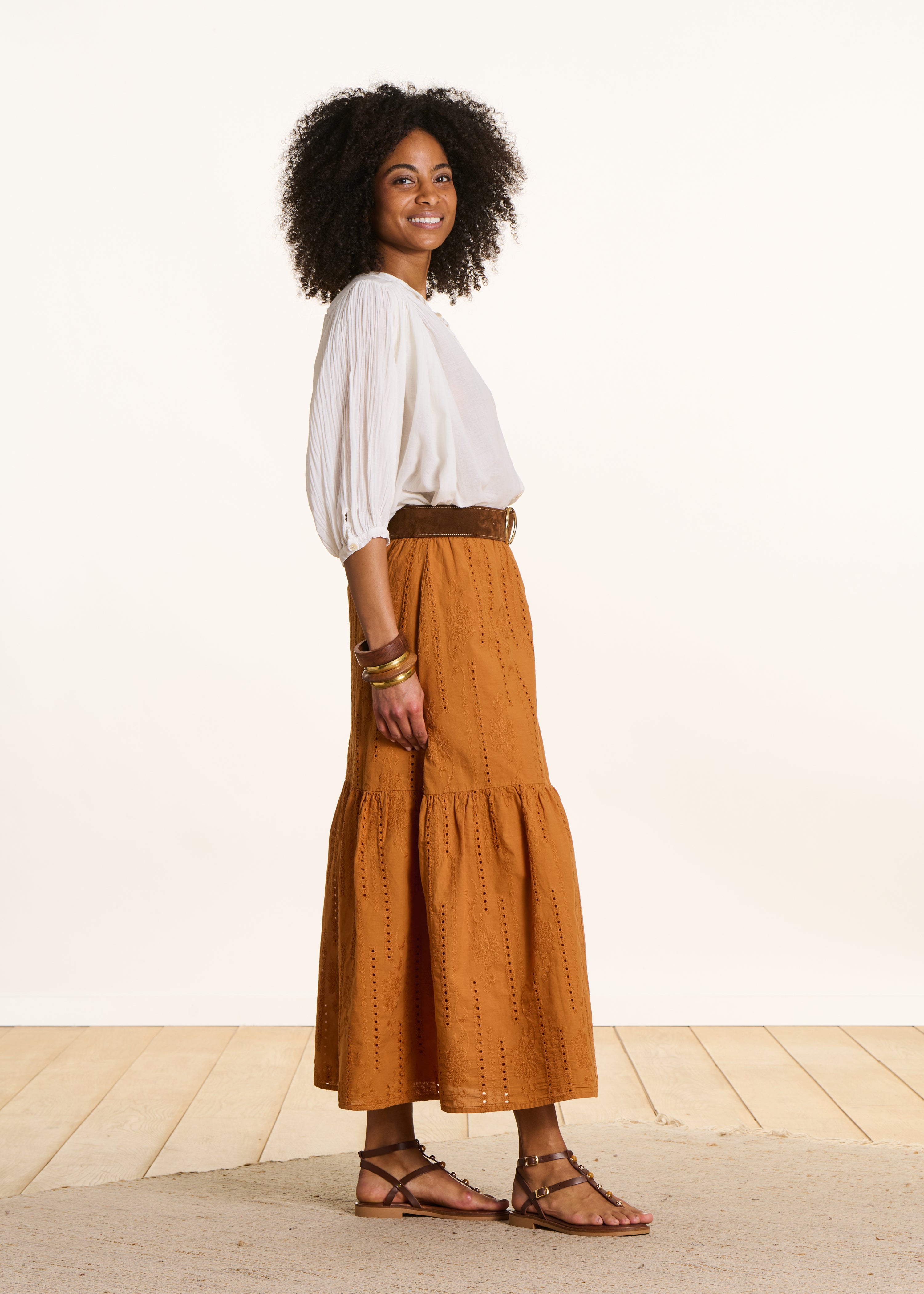 Long ochre skirt with ruffles in eyelet embroidery