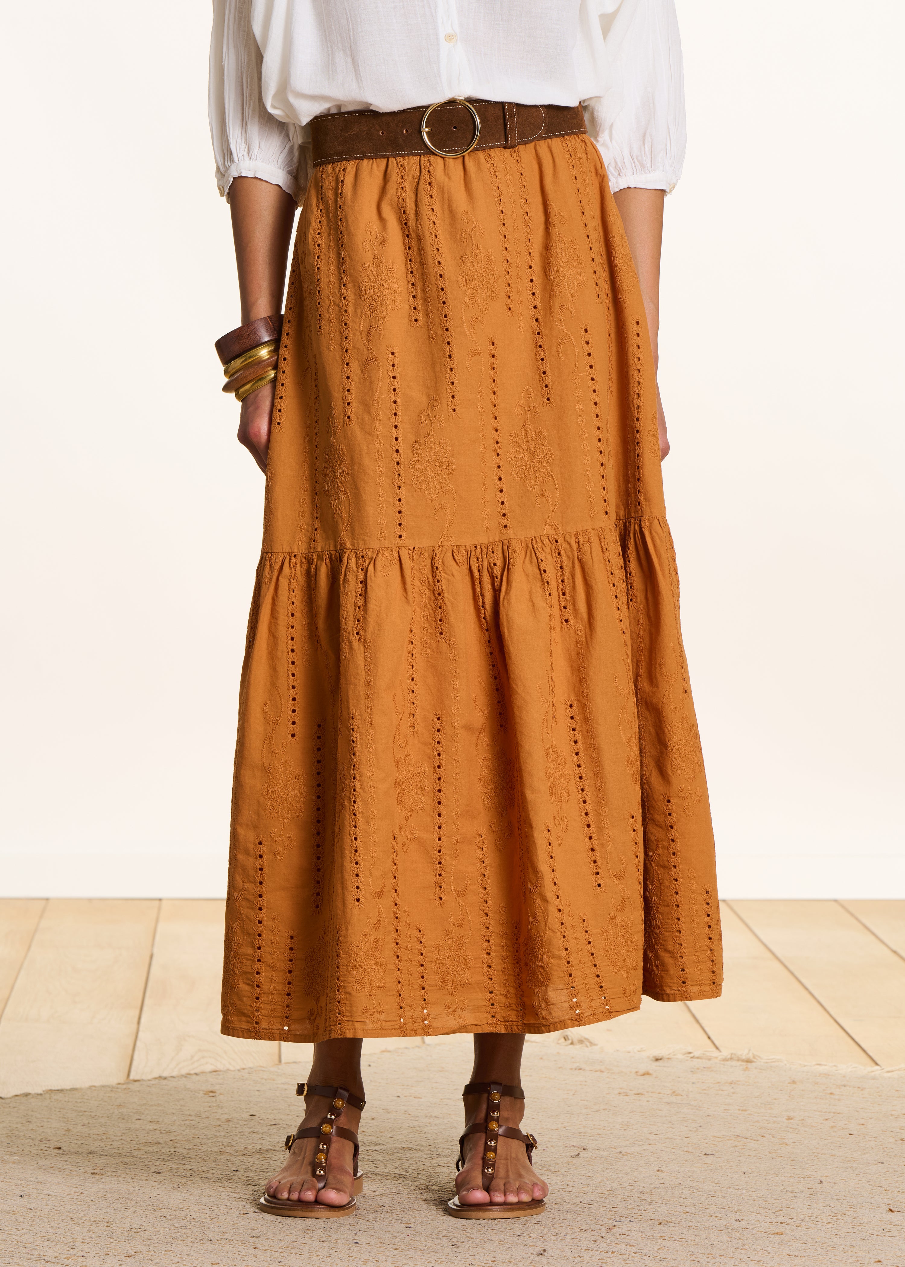 Long ochre skirt with ruffles in eyelet embroidery