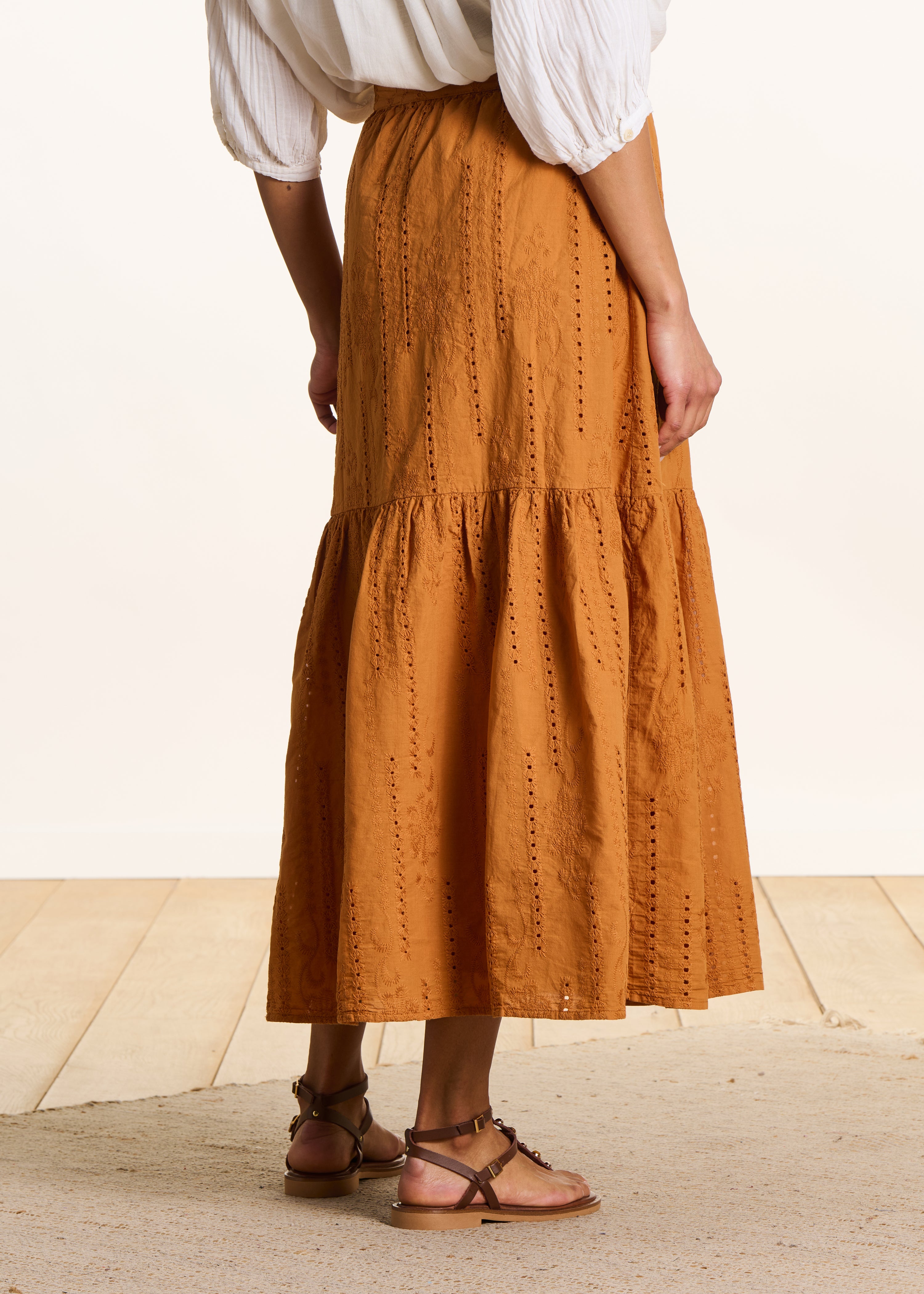 Long ochre skirt with ruffles in eyelet embroidery