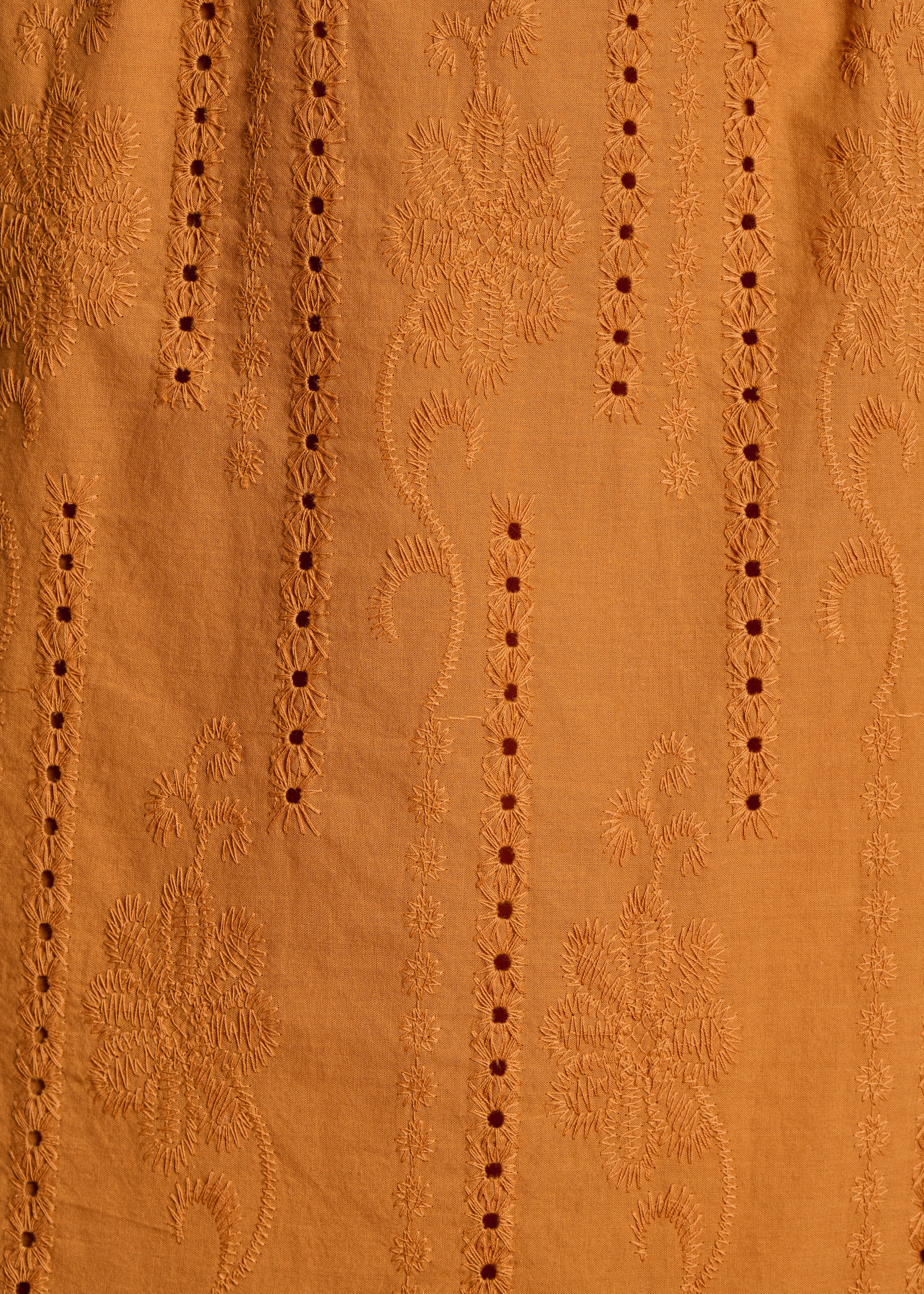 Long ochre skirt with ruffles in eyelet embroidery