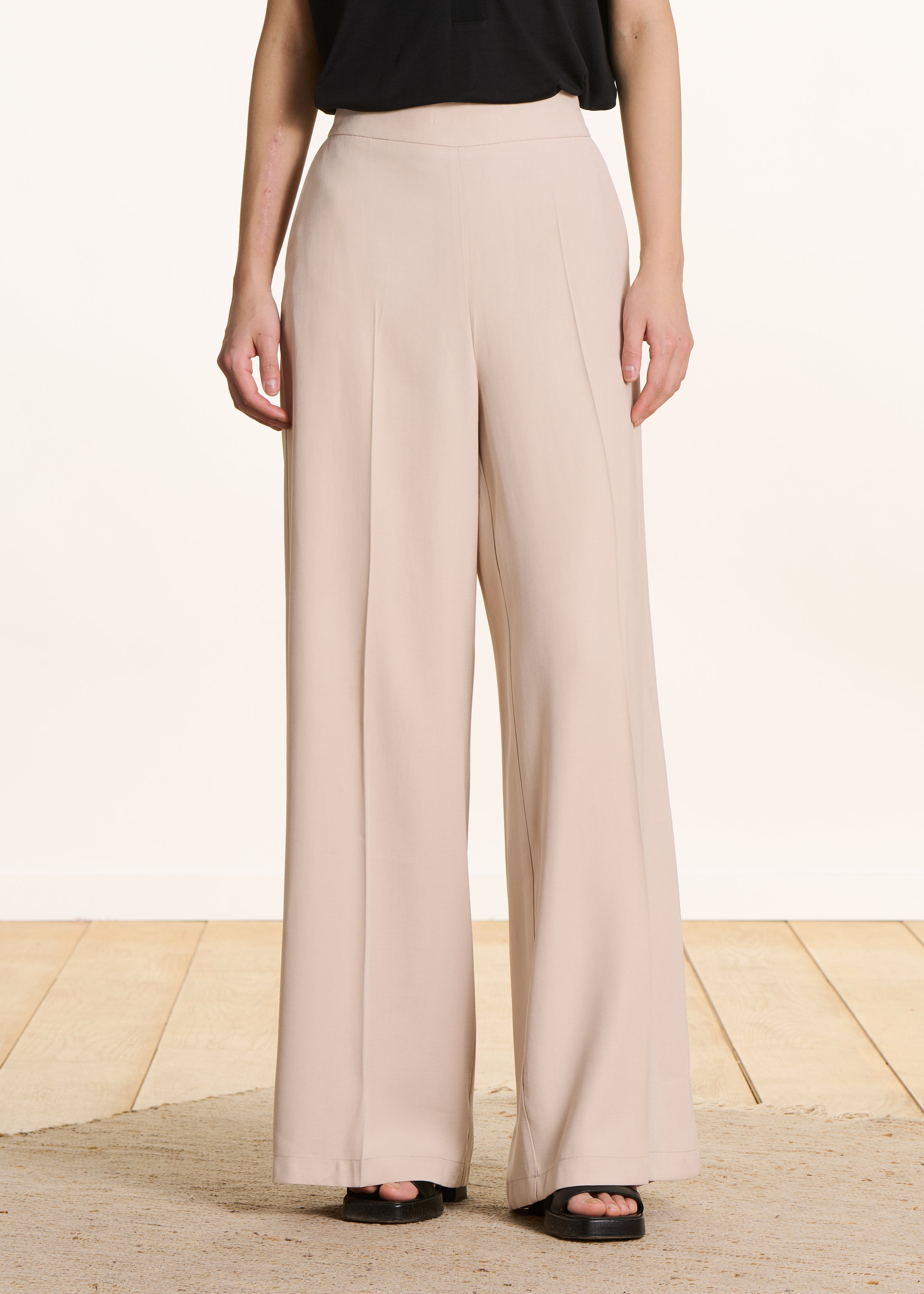 Wide beige high-waisted trousers