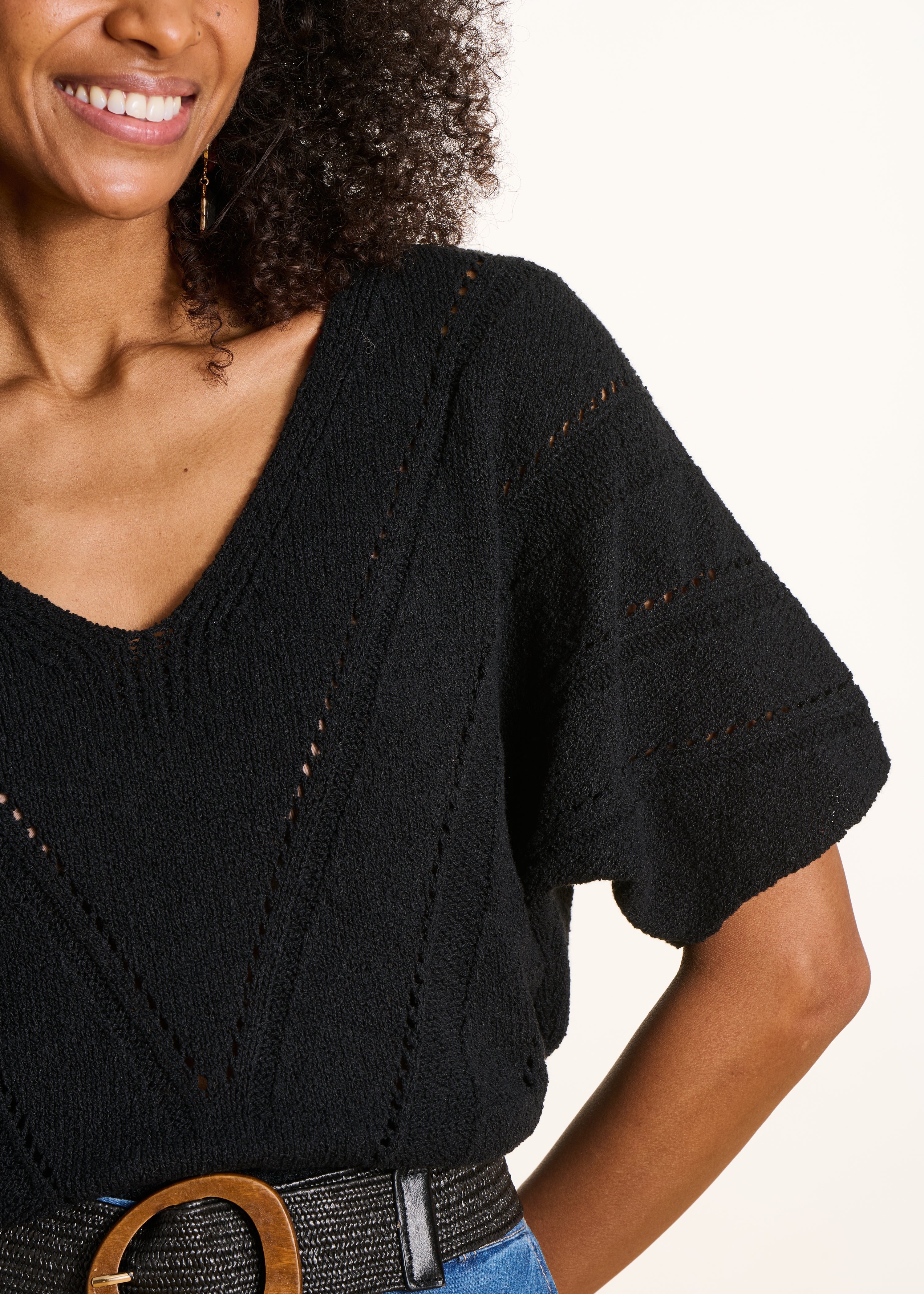 Loose black sweater in openwork knit with short sleeves