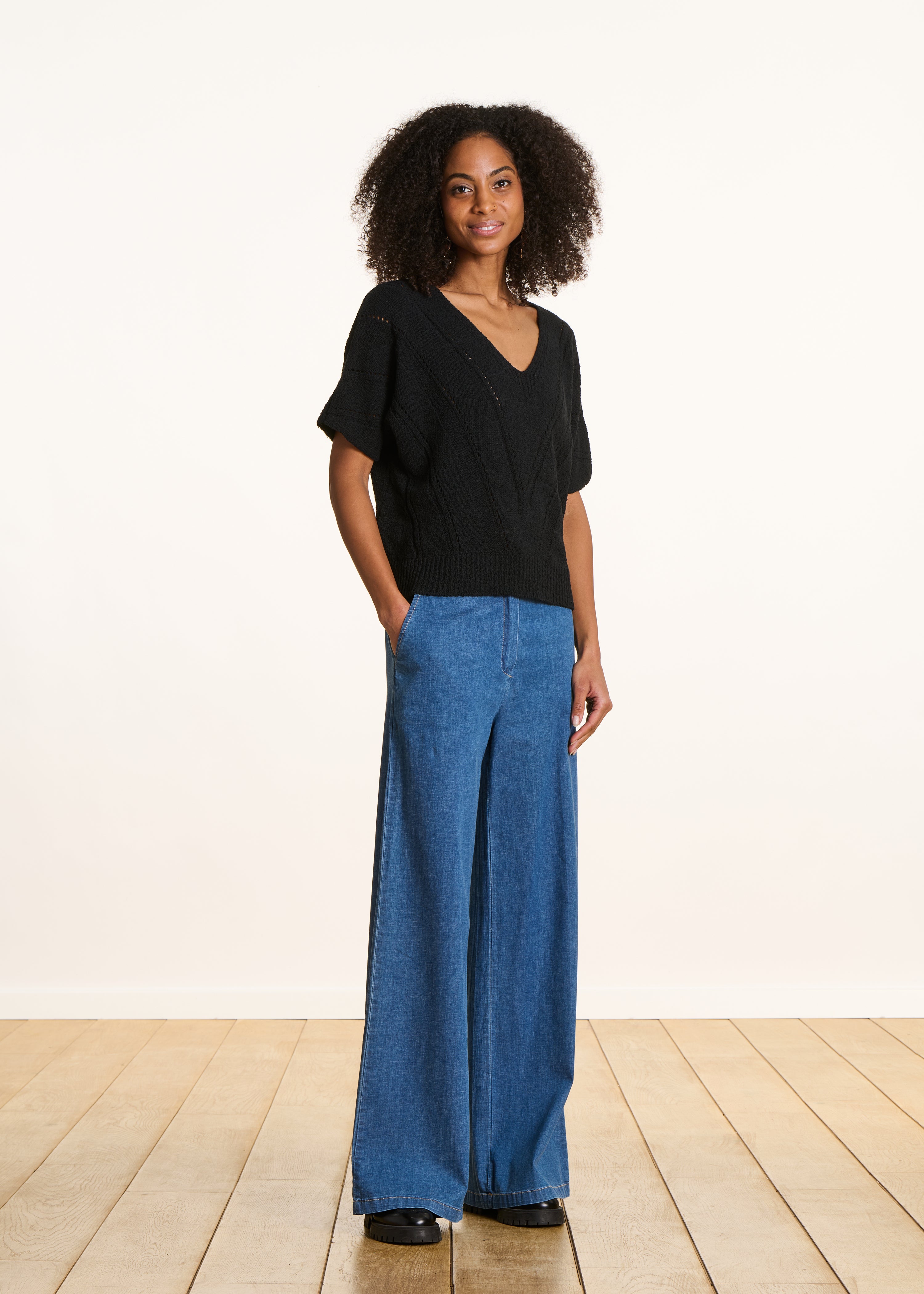 Loose black sweater in openwork knit with short sleeves