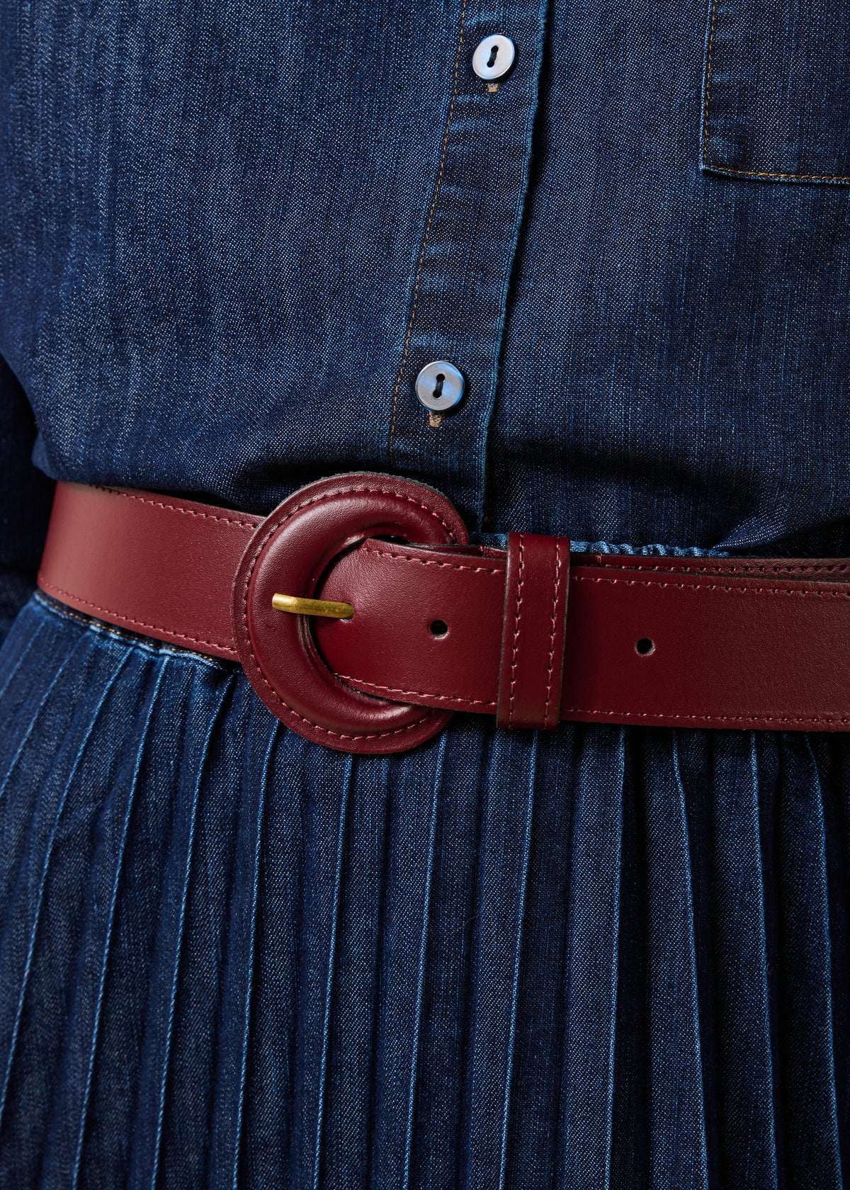 Burgundy leather belt with round buckle