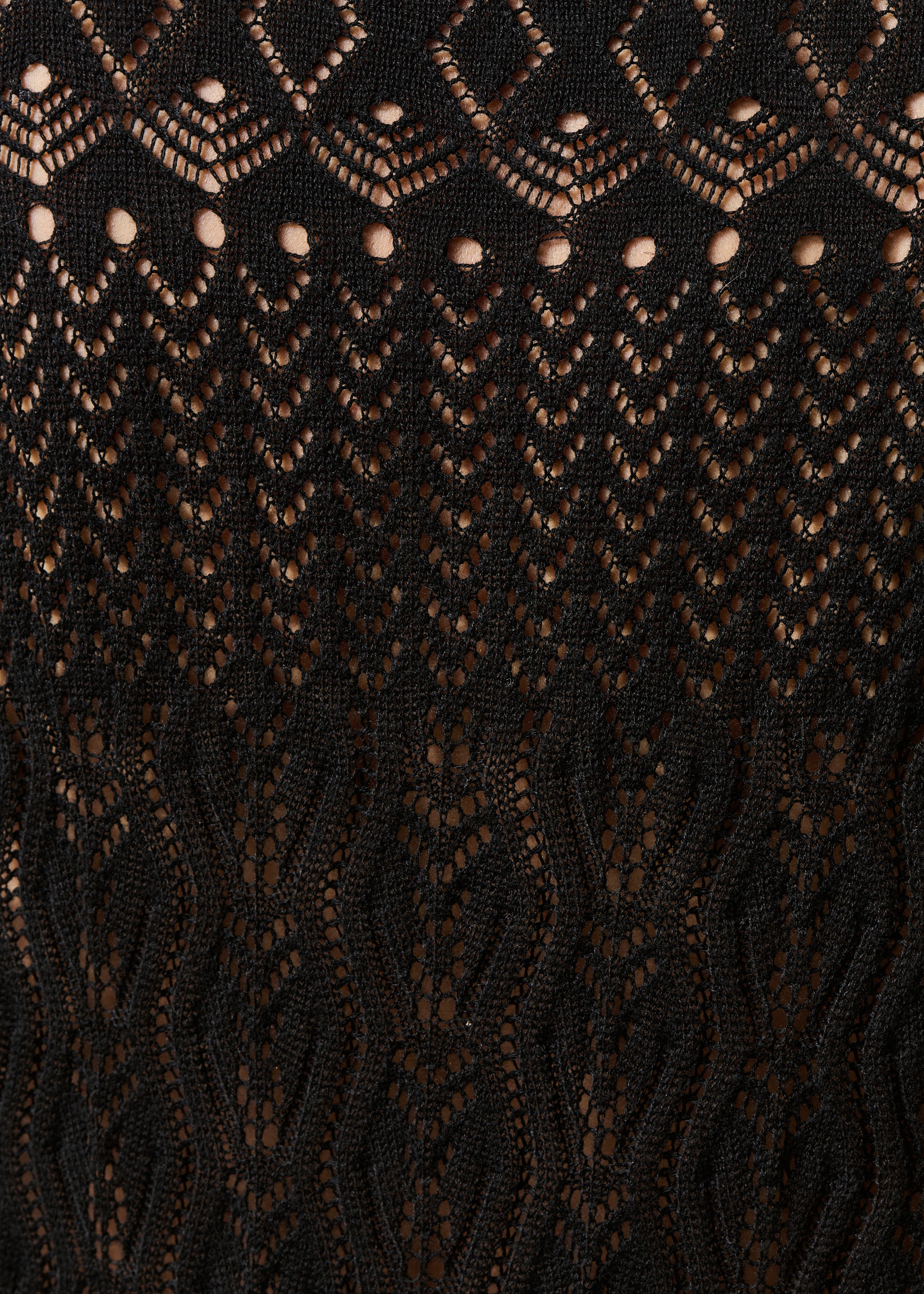 Black openwork knit sweater with long sleeves and mock neck